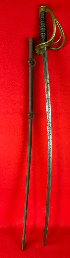 Ames Model 1860 Cavalry Sabre Dated 1863: Model 1860 Cavalry Sabre which was made by the Ames Manufacturing Company Chicopee Massachusetts. Sabre measures approximately 44" in total length with a 35" blade and has a brass guard with leather w