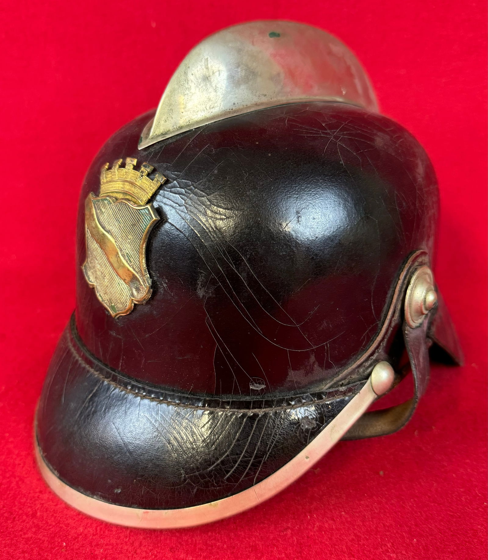 Imperial German Leather Fireman's Helmet: Imperial German fireman's helmet with nickel top ridge and visor trim etc. and a brass front shield. Helmet has its original leather liner and chinstrap and is in very nice condition .