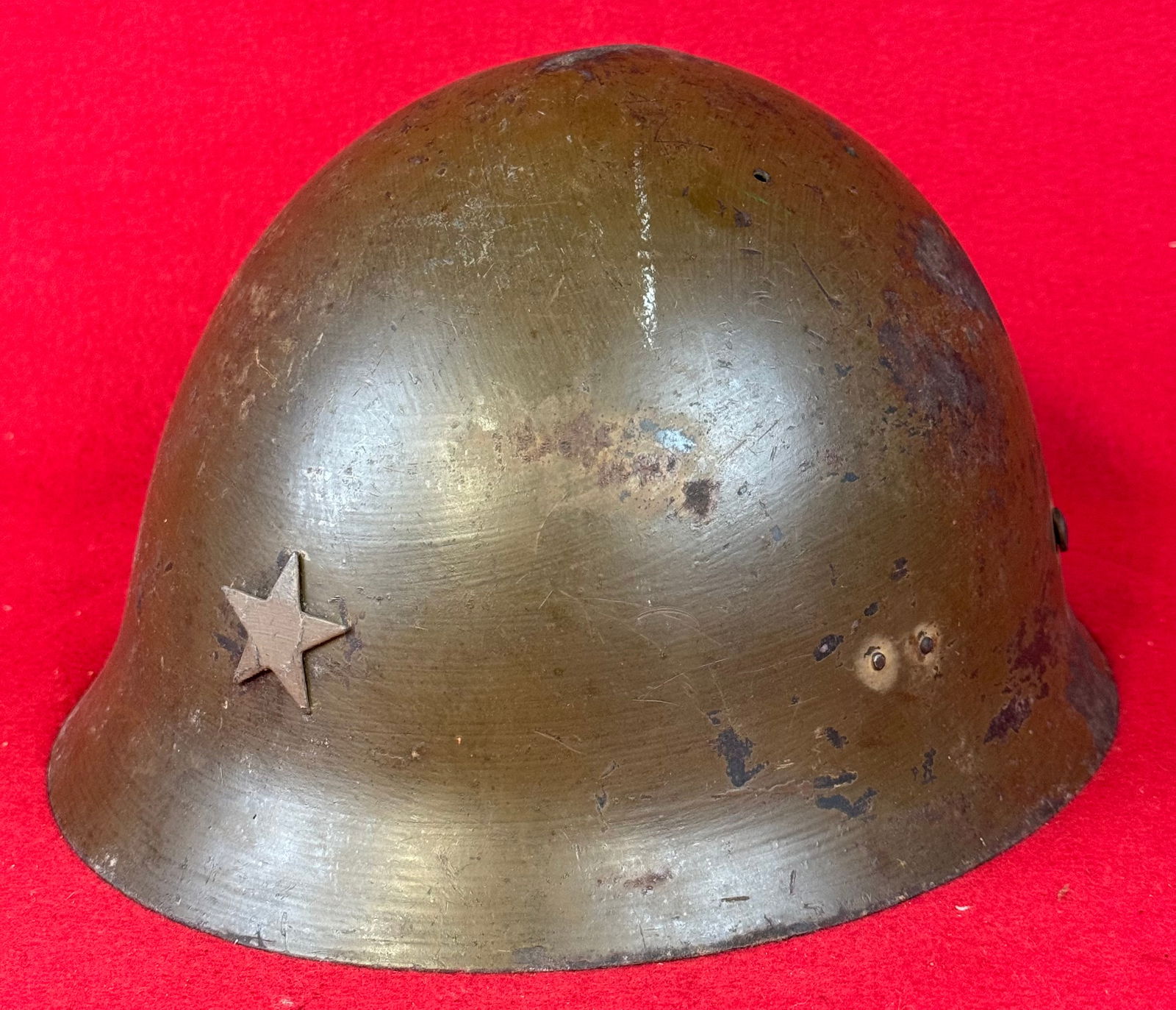 WW2 Japanese Type 90 Combat Helmet: WW2 Japanese Type 90 (also referred to as type 30/32) combat helmet with five pointed front star insignia and retaining its original liner and dark khaki finish. Helmet has some wear and some spots of