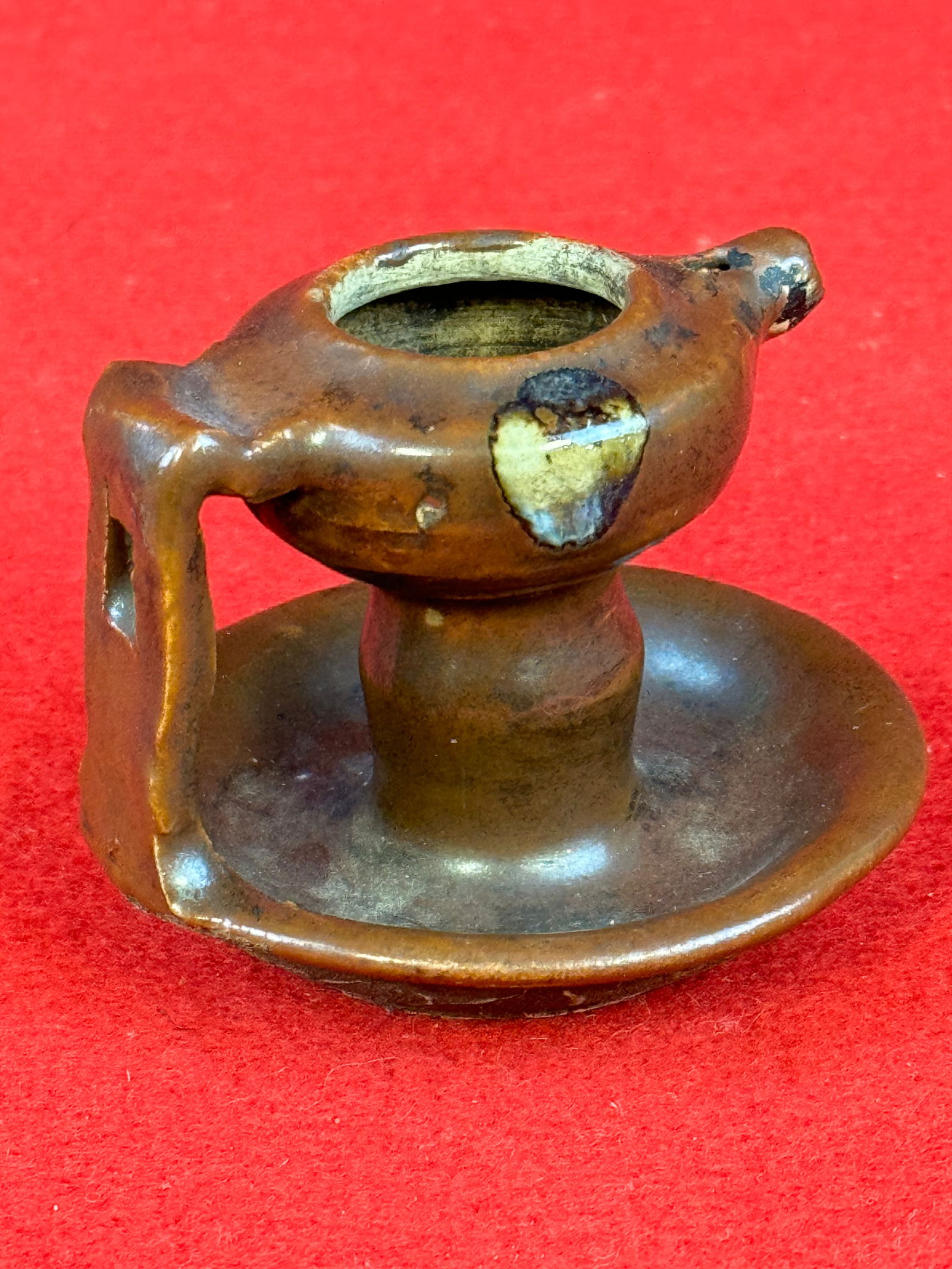 Scarce Antique Miniature Earthenware Grease Lamp: Scarce antique miniature earthenware grease lamp which is covered with a Albany brown glaze slip and is decorated on its sides. Lamp measures approximately 3" in diameter and it is 2 1/4" tall. Condit
