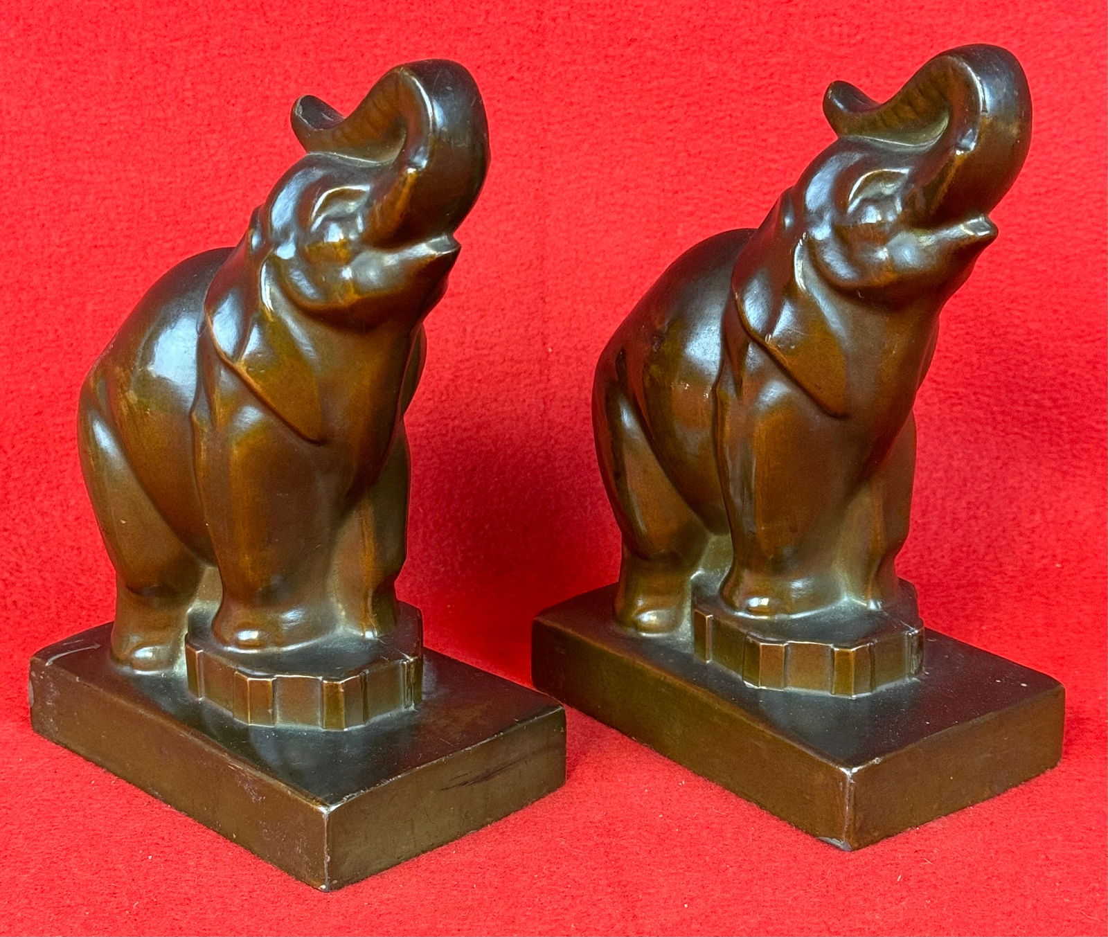 PR Vintage Bronzed Elephant Bookends: Pair of vintage bronze finished white metal elephant figural bookends which measure approximately 7" tall on a 4 3/4" by 3" base. Bookends are signed by the maker on the side of the bases but its hard