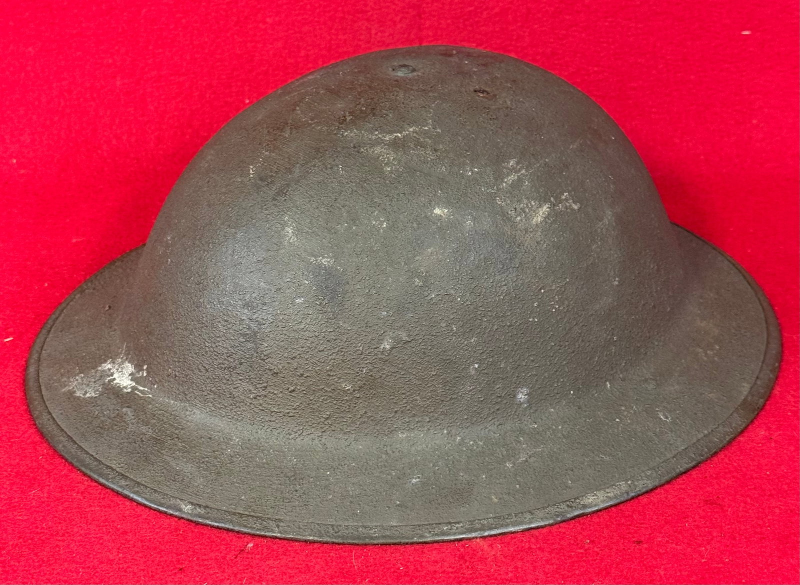 WW1 Doughboy Helmet With Textured Finish: World War One doughboy style helmet with textured olive finish and complete with its original liner and chinstrap. Helmet is in nice condition with just some minor wear as shown.