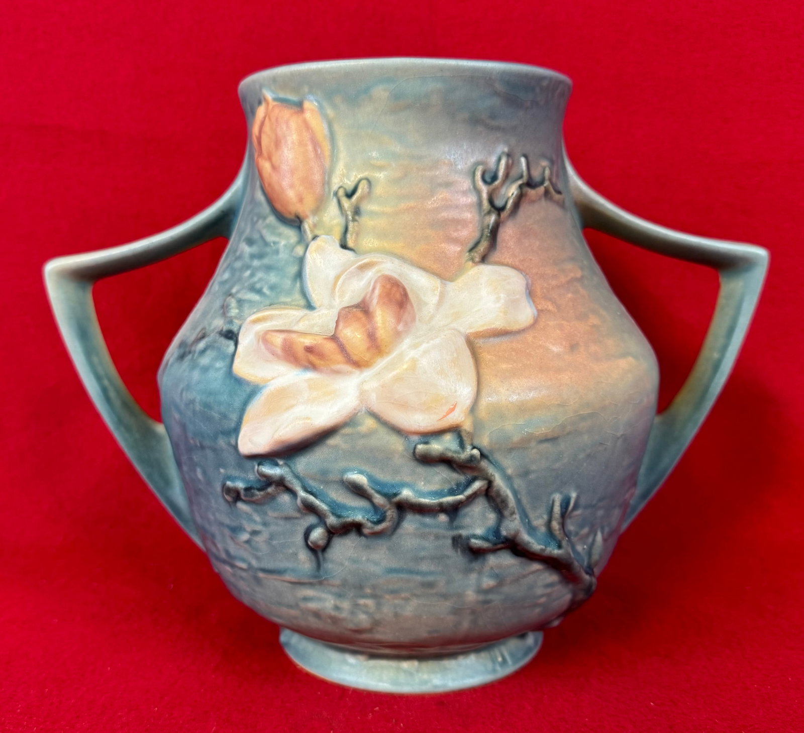 Roseville Blue Magnolia 8 1/4" Double Handled Vase 91-8": Original Roseville 91-8" double handled vase in the Magnolia pattern which dates to 1943. Vase is marked on underside of the base in relief Roseville / U.S.A. / 91-8" and is in the blue coloration. Va