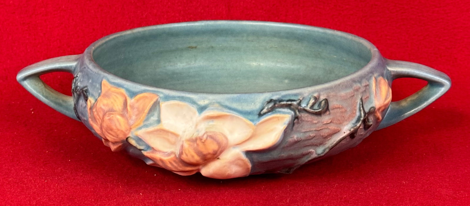 Roseville Blue Magnolia Double Handled low bowl 447-6": Original Roseville 447-6" double handled low bowl in the Magnolia pattern which dates to 1943. Bowl is marked on underside of the base in relief Roseville / U.S.A. / 447-6" and is in the blue colorati
