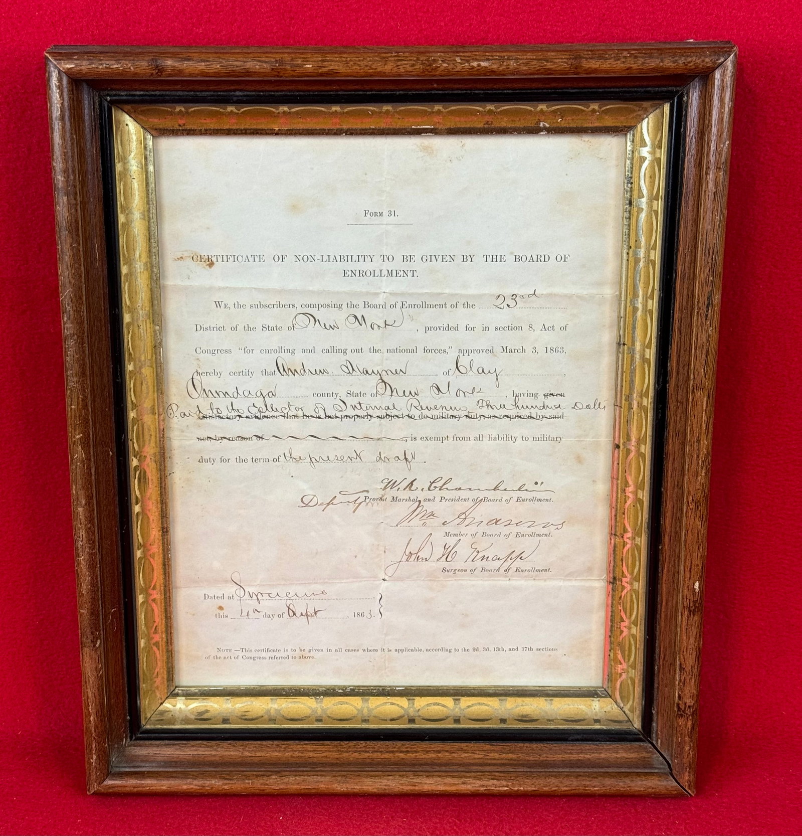 1863 State Of NY Exemption Certificate: 1863 exemption certificate for a Andrew Haymen? from Syracuse New York who apparently paid the 300 dollars for an exemption to the draft. Document is framed in a 1860-70 period deep dish walnut frame.