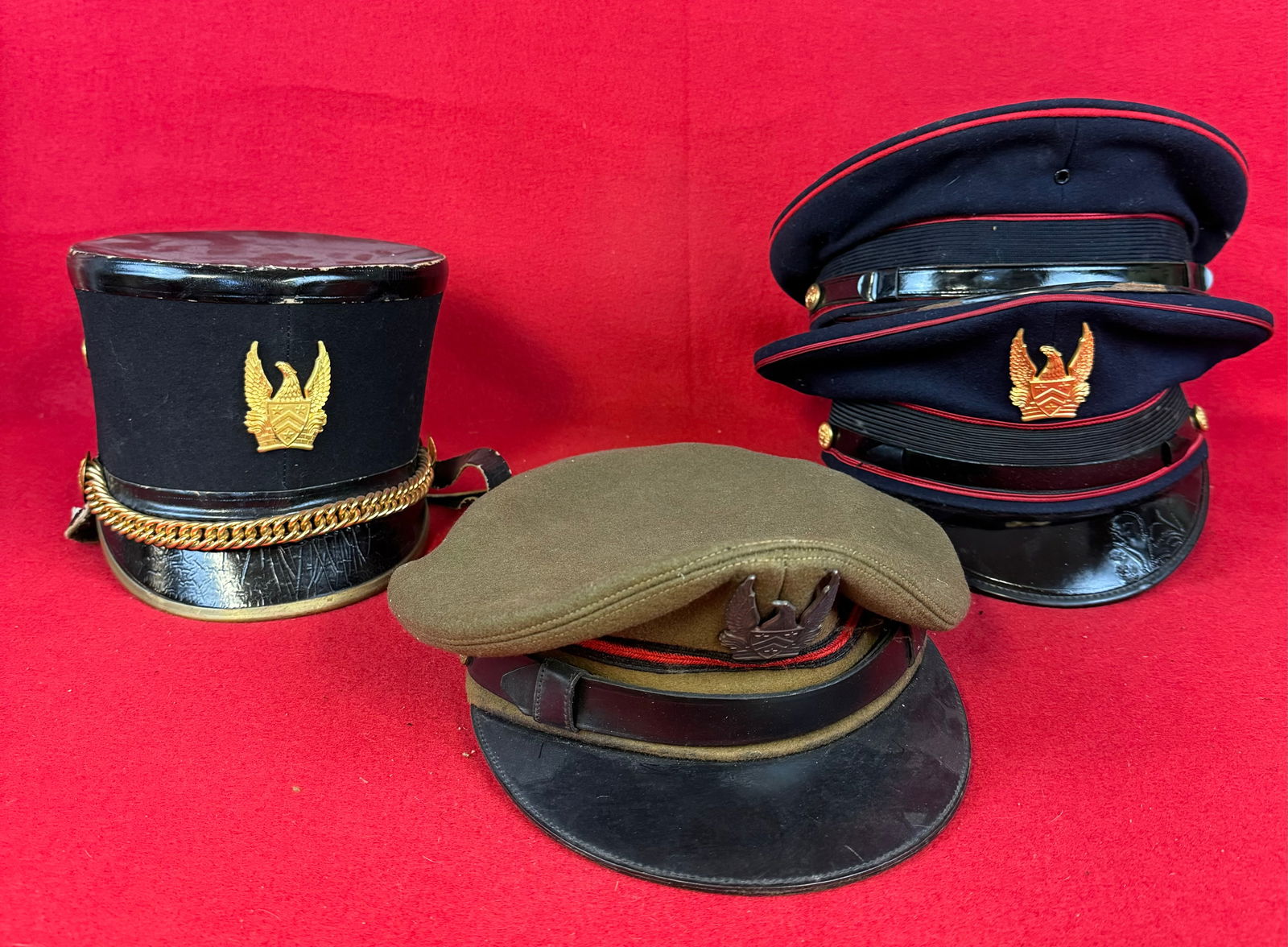 Lot 4 Vintage US Military Visor Caps & Shako: Lot of four United States Military caps etc. to include three visor caps two with insignia at front along with a shako with front insignia. Condition - generally fine with just some minor wear and soi