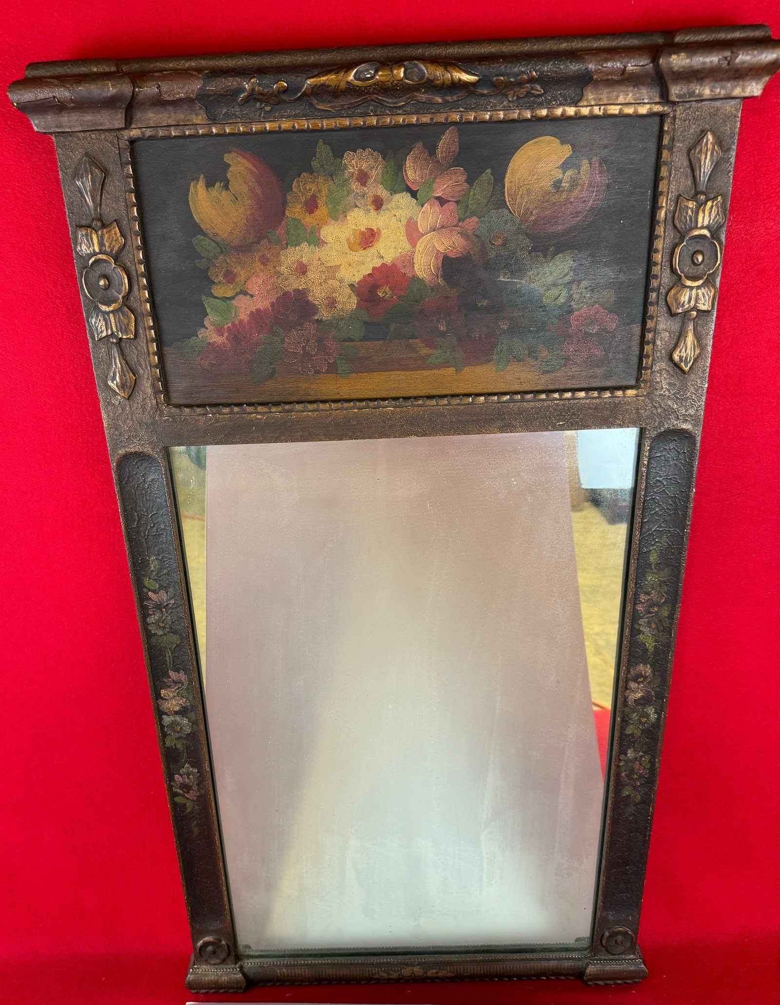 Vintage Wall Mirror With Floral Painted Top Tablet: Early 20th century wall mirror with a floral painted tablet at the top and having a gesso over wood painted frame. Mirror measures approximately 36" by 20'. Condition - some inpainting to some gesso l