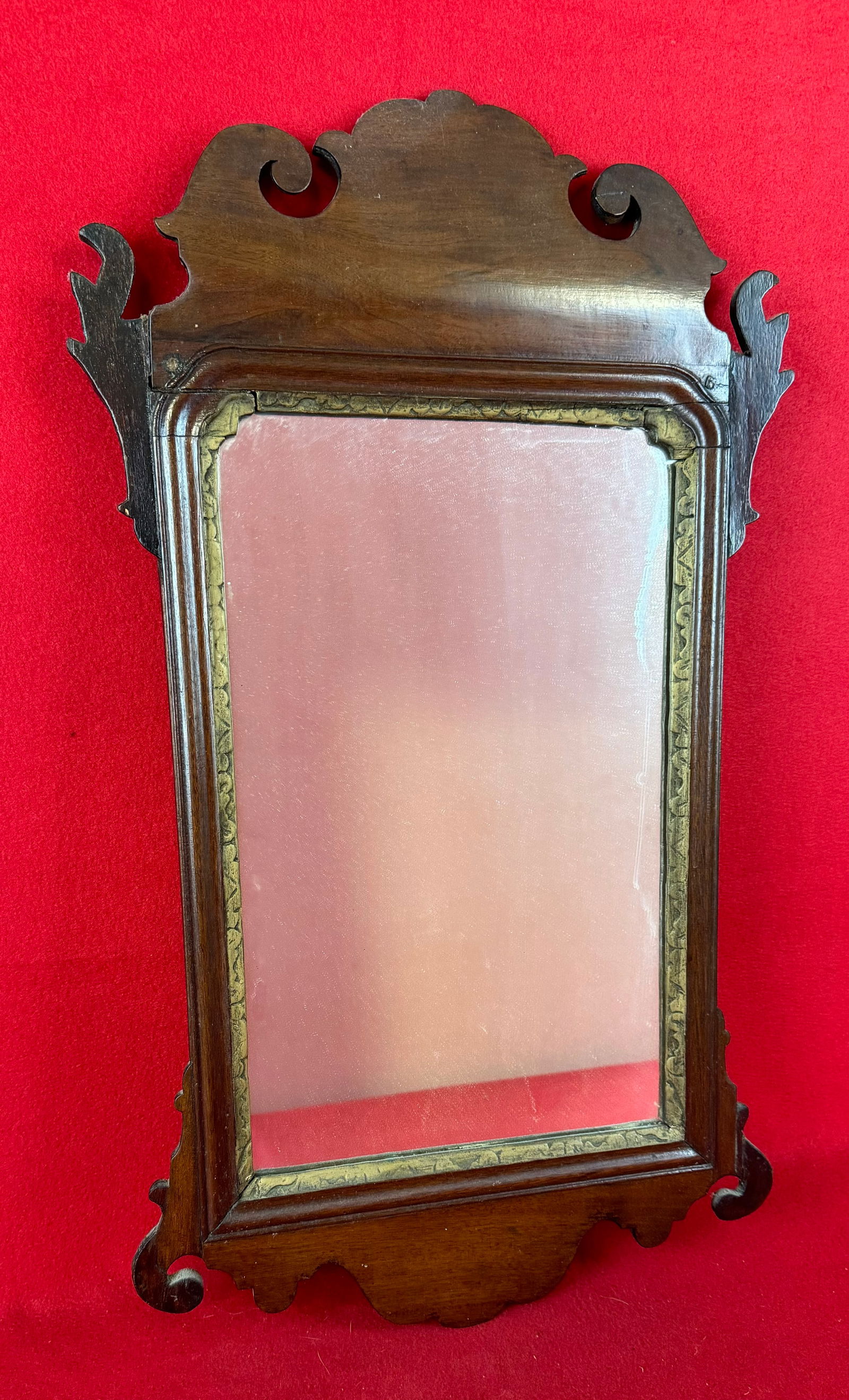 Antique Chippendale Wall Mirror: Antique Chippendale wall mirror which measures approximately 26" by 15". Condition - mirror glass is a old but later replacements and frame exhibits some old repairs as shown but a period Chippendale