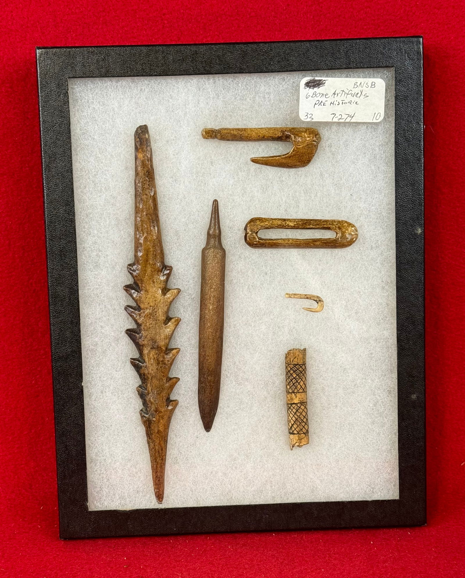 Lot 6 Prehistoric Bone Artifacts: Lot of fine prehistoric bone artifacts to include fish hooks, barbed spear point, awl and tubular bead. The longest item being the barbed spear point measures approximately 7" long. Condition - is as