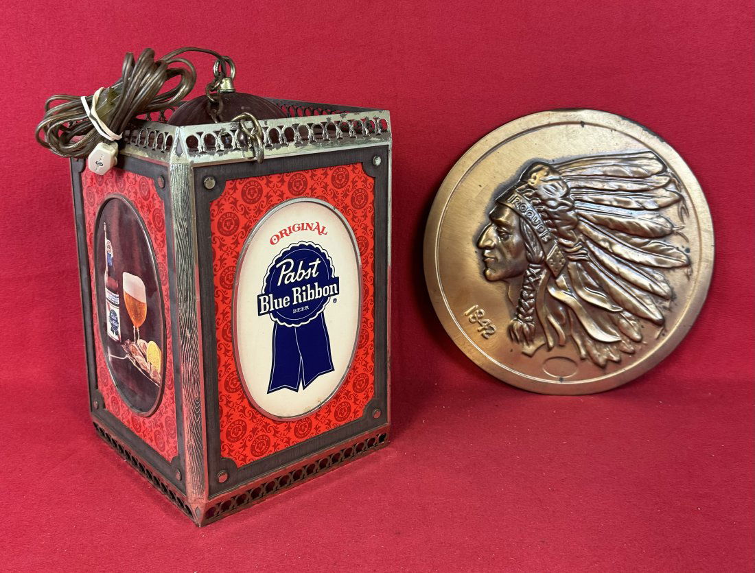 Lot 2 Beer Advertising Items Pabst & Iroquois: Lot of two vintage beer advertising items which includes a gold painted tin sign for Iroquois Beer 12" diameter together with a Pabst Beer hanging light made of plastic. Condition - some wear as shown