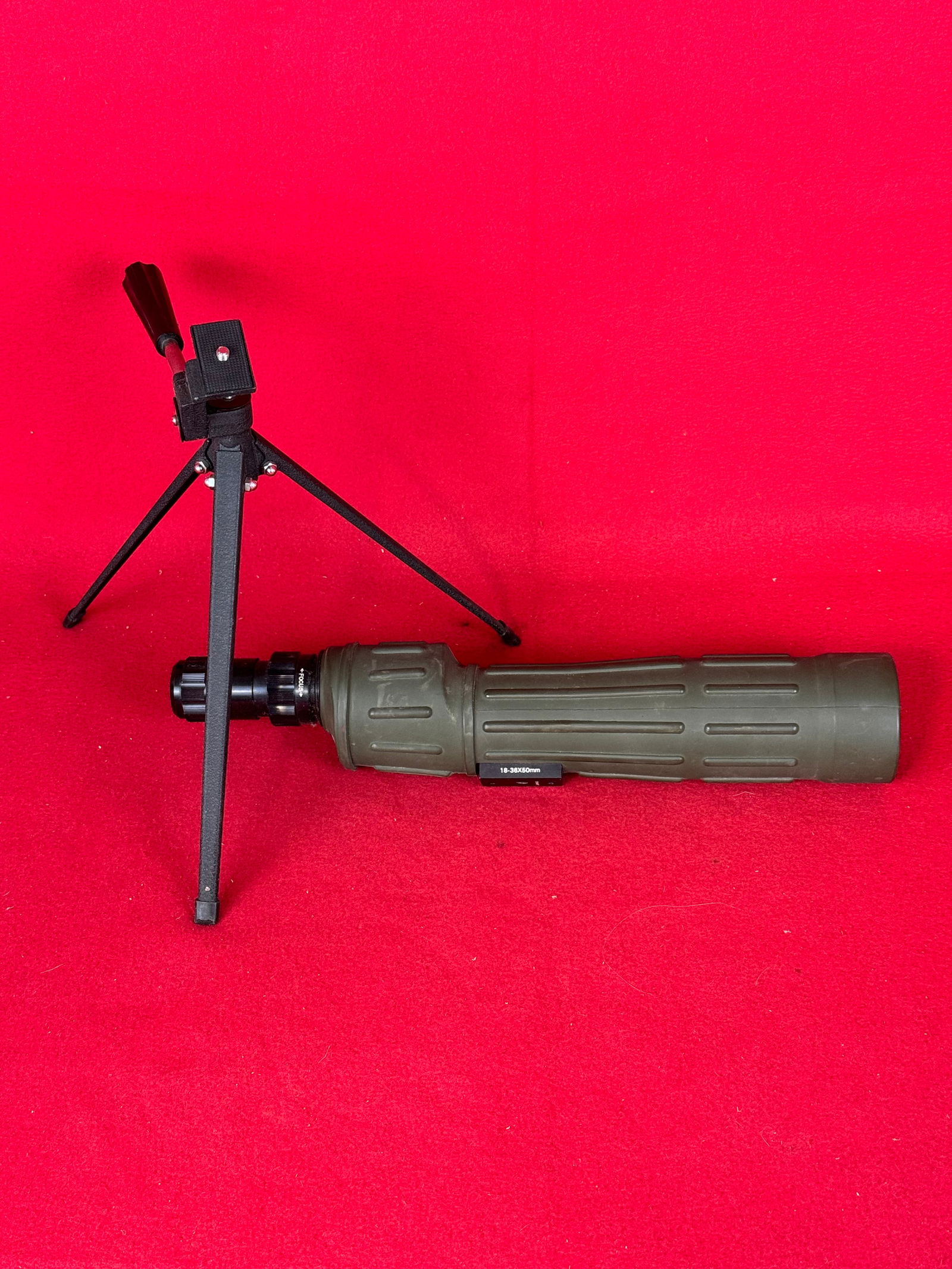 Tasco 34TZ 18-36x50mm Spotting Scope: Tasco Model 34TZ 18-36x50mm spotting scope with a green rubberized covering and having a tripod. Spotting scope is in fine condition with just some minor use wear as shown.