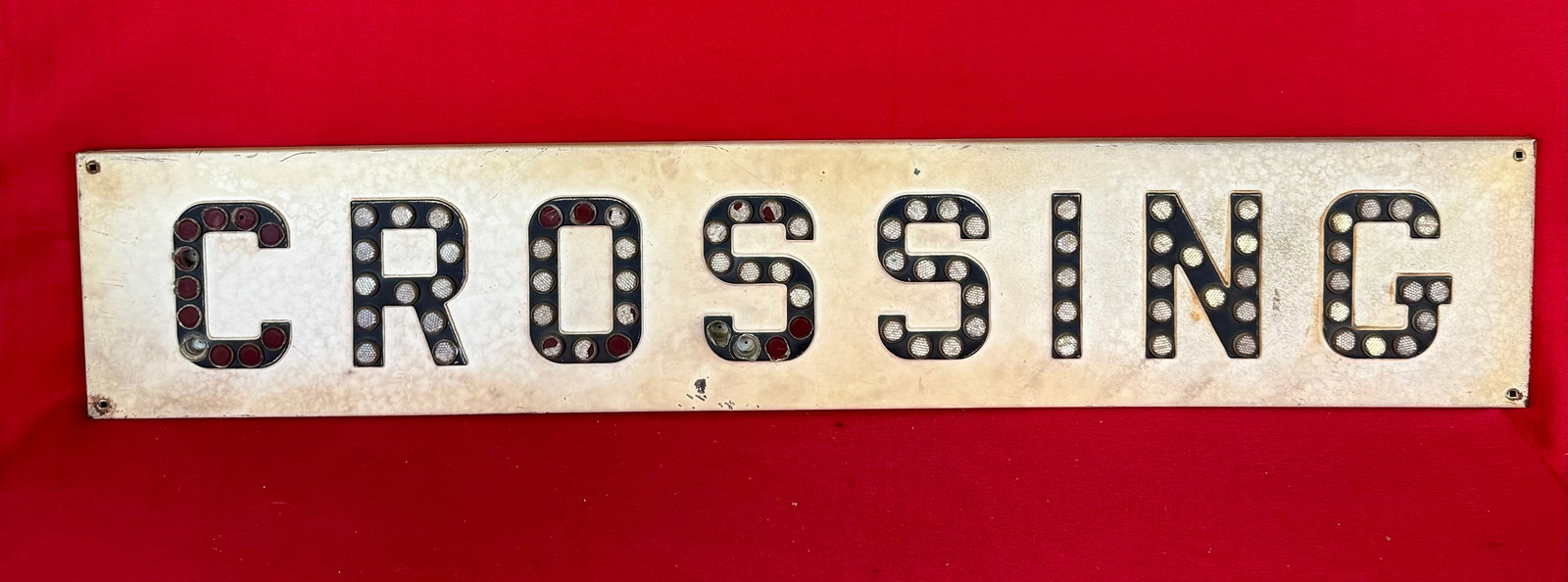 Vintage Metal Railroad Crossing Sign: Vintage Metal Railroad "CROSSING" sign which measures approximately 48" long by 9" tall by 3/4" thick. Sign's letters are inset with reflectors. Condition - some minor wear to its original white paint