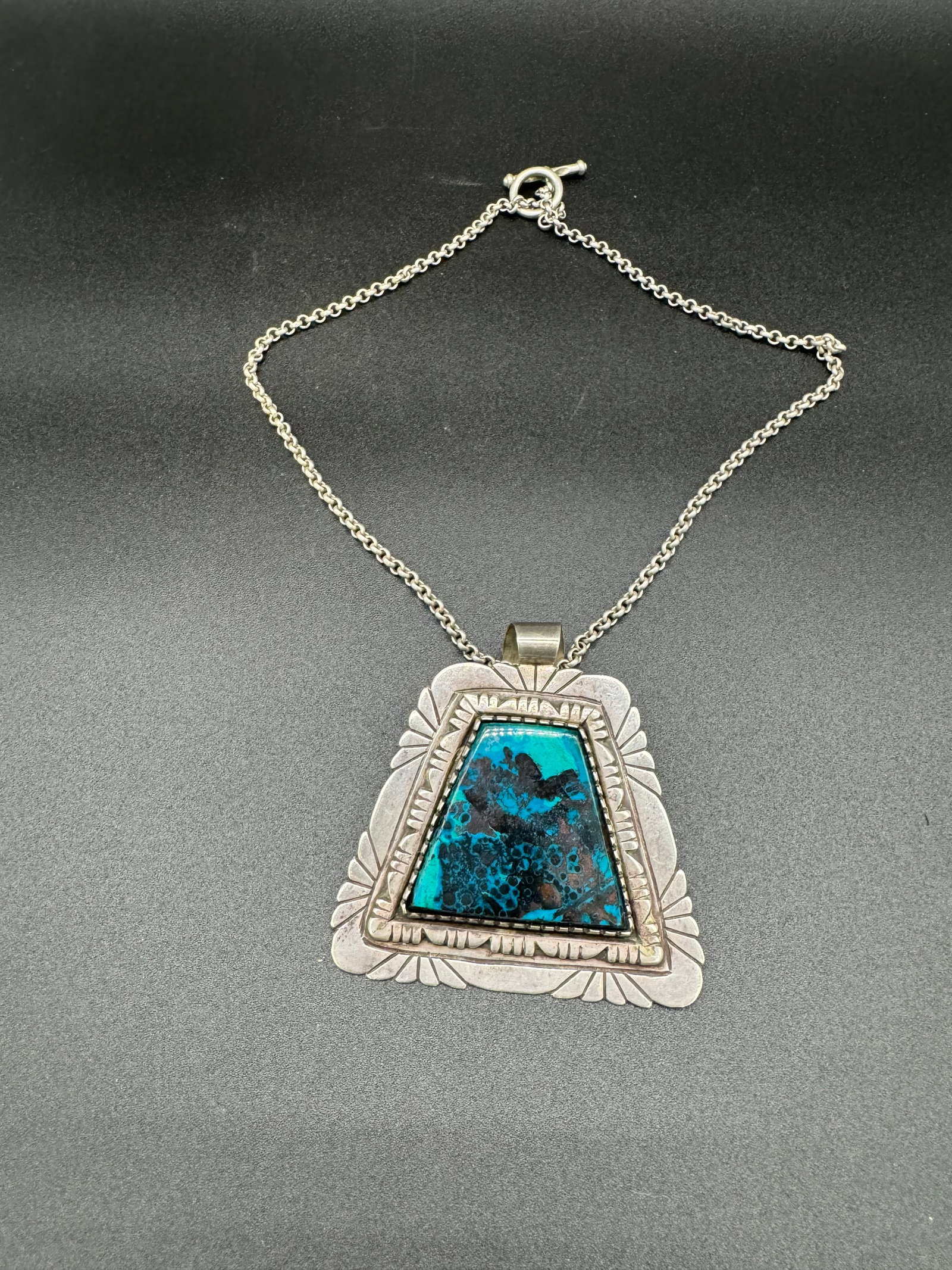 Lg Navajo Sterling & Turquoise Pendant With Chain: Large Navajo sterling silver with turquoise stone pendant which is signed by the artist on the reverse with a A with a line above. The pendant comes with a matching sterling silver chain. The pendant