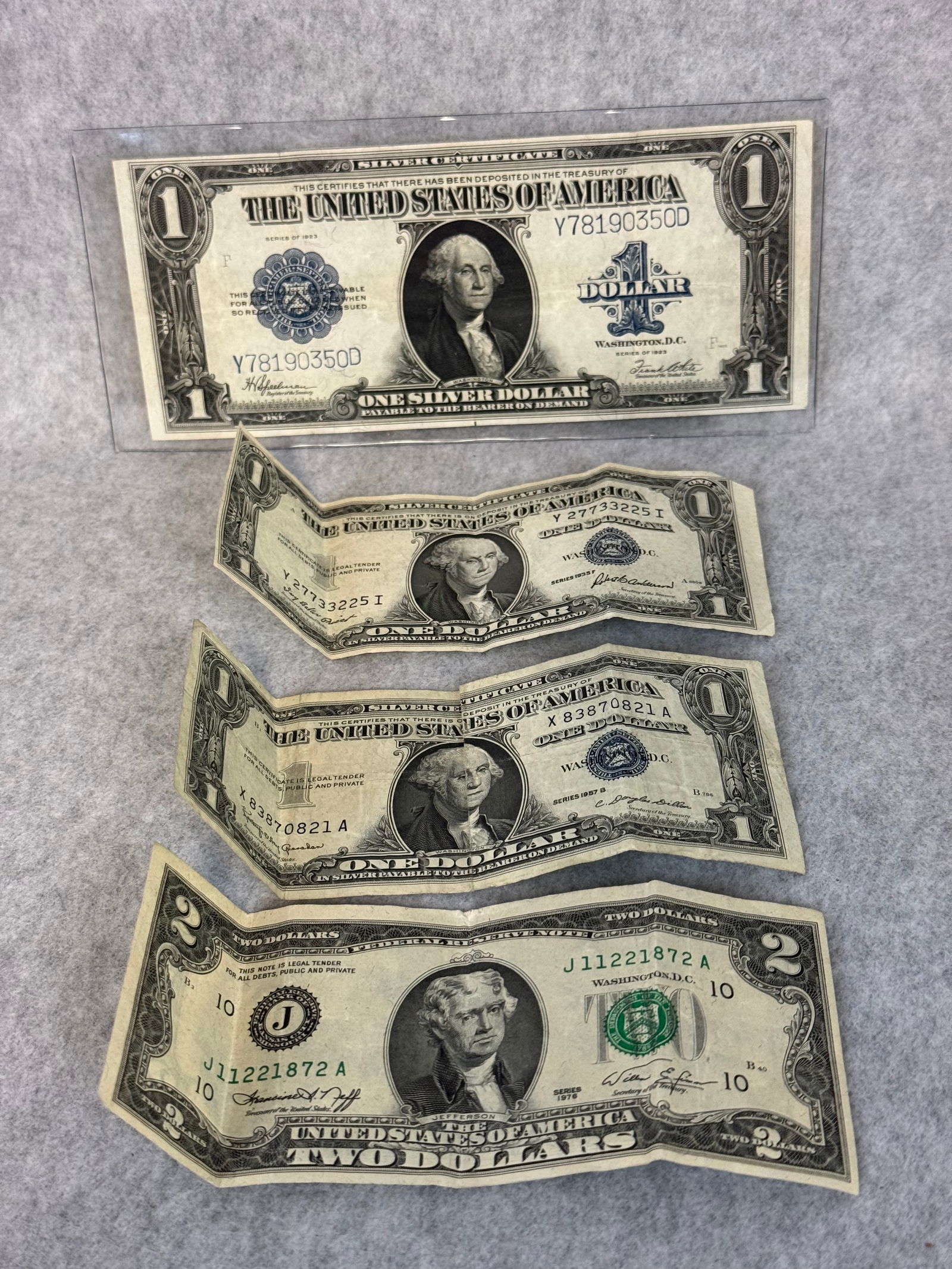 Lot Silver Certificates w/ 1923 One Dollar Bill: Lot To Include Series 1923 Spellman / White One Dollar Large Size Silver Certificate, a series 1935 F One Dollar Silver Certificate, a series 1957 B One Dollar Silver Certificate and a series 1976 Two