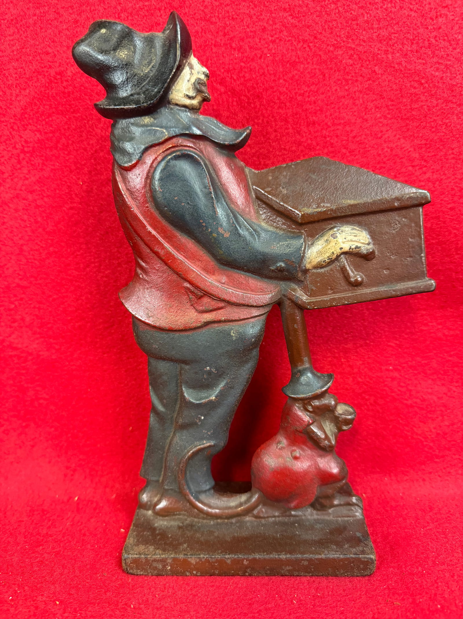 Organ Grinder & Monkey Cast Iron Doorstop: Original cast iron organ grinder and monkey doorstop with its exceptional all original factory paint. Doorstop measures approximately 9 7/8" tall. Doorstop is pictured on page 207 of the doorstop book