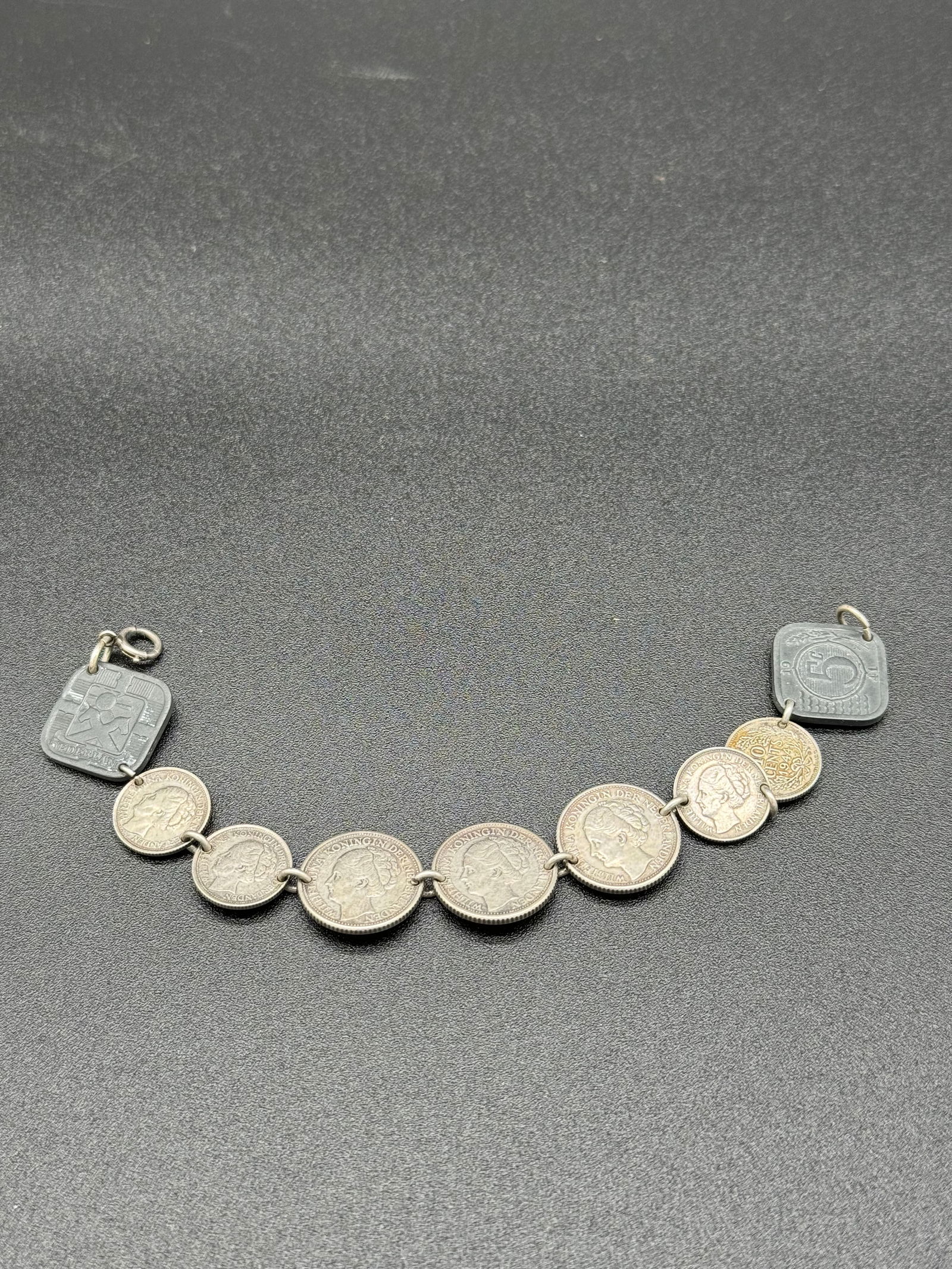 WW2 Era 1944 Netherlands Coin Bracelet: World War Two era bracelet made from 10 and 25 cent coins (.64 silver) from the Netherlands and two 1941 5 cent coins at the ends. The bracelets total weight is .80 ozt and the bracelt is approximatel
