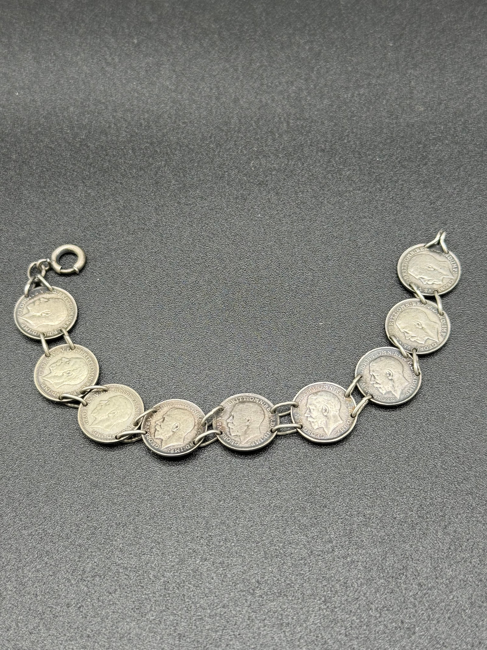 Bracelet Made From British 3 Pence Coins: Bracelet measuring approximately 7 1/2" long which is made from old British 3 pence silver coins. The bracelet weights .48 ozt. Condition - fine just in need of a good polishing.