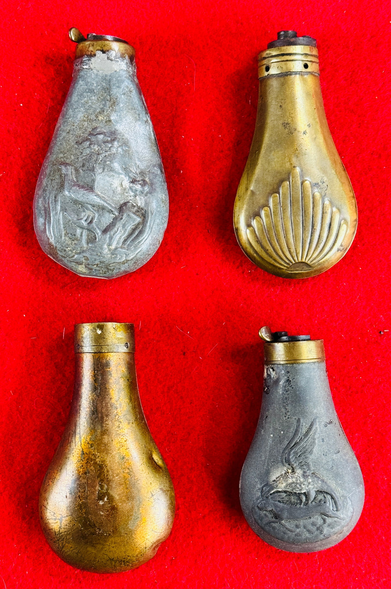 Lot 4 Antique Pistol Size Powder Flasks: Lot of four antique pistol size powder flask two of which have a zinc body and two have a brass body. Powder flasks are in as is condition lacking parts as shown etc.
