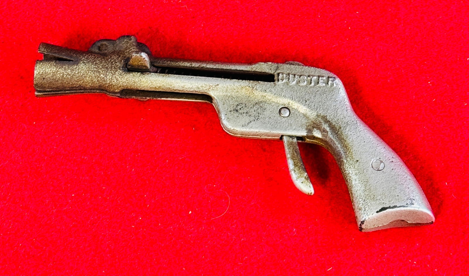 Scarce Antique "BUSTER" Cap Gun: Scarce antique "BUSTER" nickel plated cast iron cap gun which measures approximately 6" long. Condition - working with just some surface oxidation near muzzle as shown.