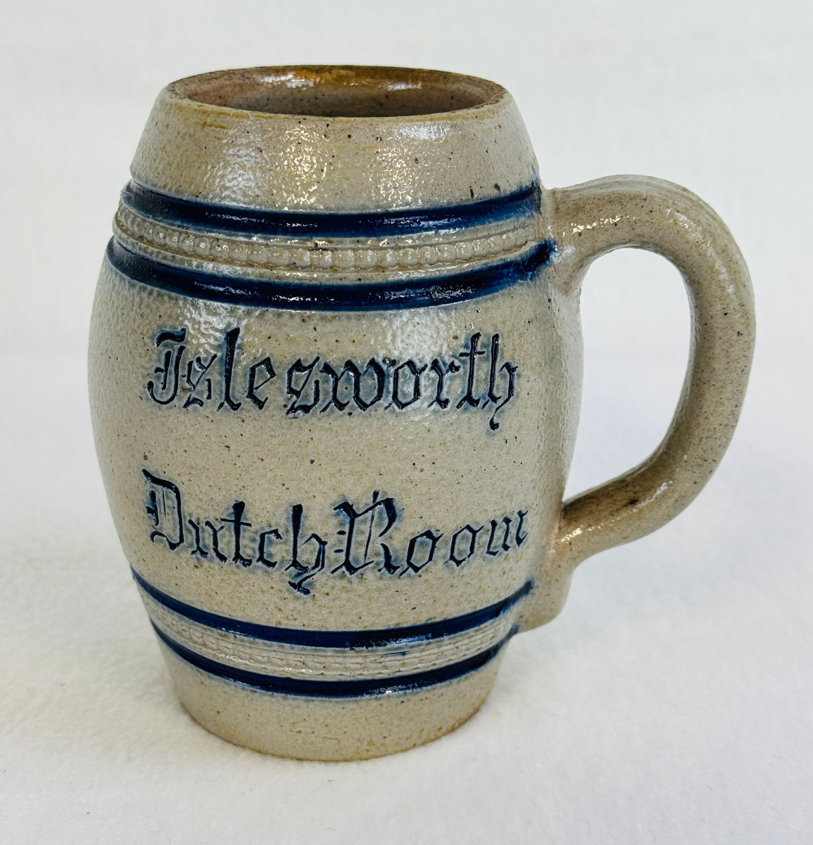 Islesworth Dutch Room Barrel Form Stoneware Mug: Blue and white molded stoneware mug which is debossed at front Islesworth / Dutch Room. Mug stands approximately 4 3/4" tall and is in excellent condition.