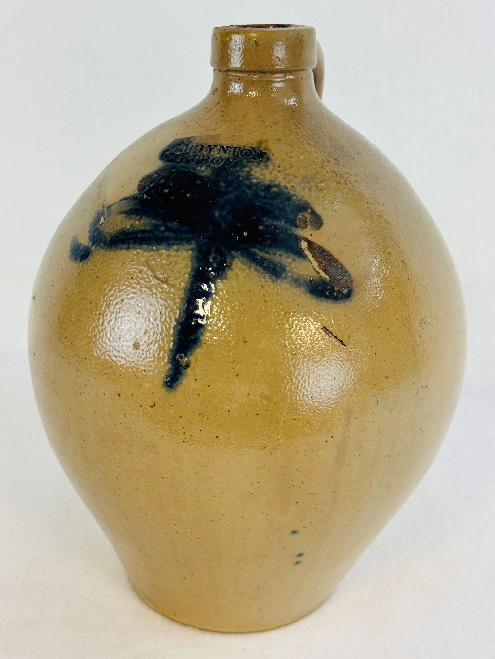 Calvin Boynton Troy Ovoid Jug With Blue Floral: 13 1/2" ovoid stoneware jug which is stamped C. Boynton / Troy (1829-1835) which is decorated with a blue floral at front. Condition - in making chip to proper right side and kiln touch mark to right