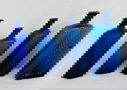 Lot 4 Cobalt Blue Poison Bottles: Lot of four blown in mold with tooled tops cobalt blue glass poison bottles the largest of which measures approximately 7 5/8" tall. Condition - bottles appear to be free of any chips or cracks but th