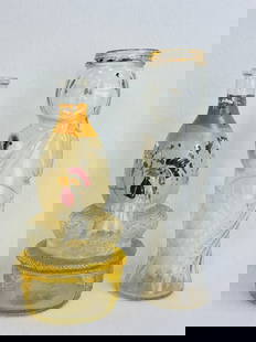 Lot 2 Figural Bottles Hen On Nest & Mermaid: Lot of two clear glass figural bottles one being a 9 1/2" tall ABM bottle in the form of a hen on nest which originally held liquor together with a 10 1/2" tall ABM screw top bottle in the form of wha