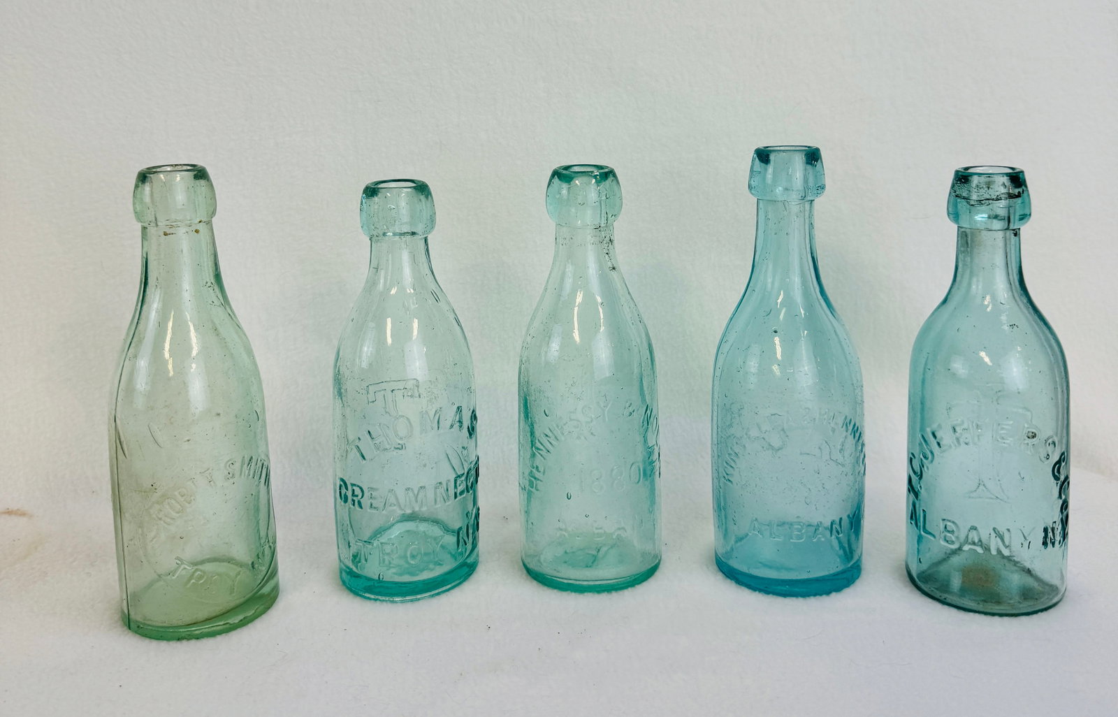 Lot 5 Squat Sodas Albany & Troy NY: Lot of five Capital Region of NYS aquamarine squat sodas to include a T C Jeffer's & Co Albany N.Y. (excellent), Kinsella & Hennessy Albany N.Y. (some surface wear), Hennessy & Nolan 1880 Albany (clea