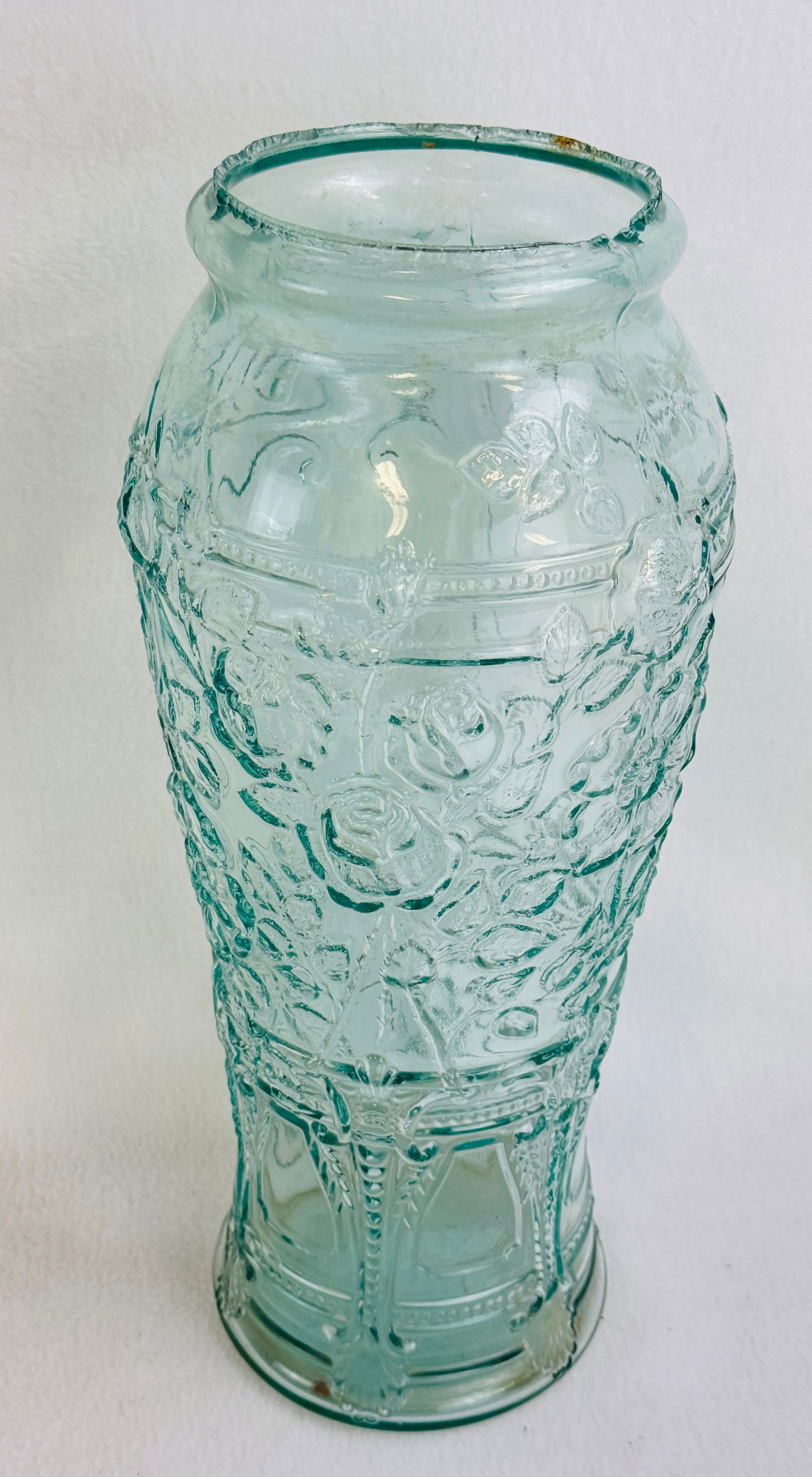 15" Aquamarine Goofus Glass Pickle Jar: 15" aquamarine goofus glass pickle jar which is embossed with roses and ornate panels. Condition - roughness at top edge as made otherwise fine. Note: Most items in this auction we will offer our in-h