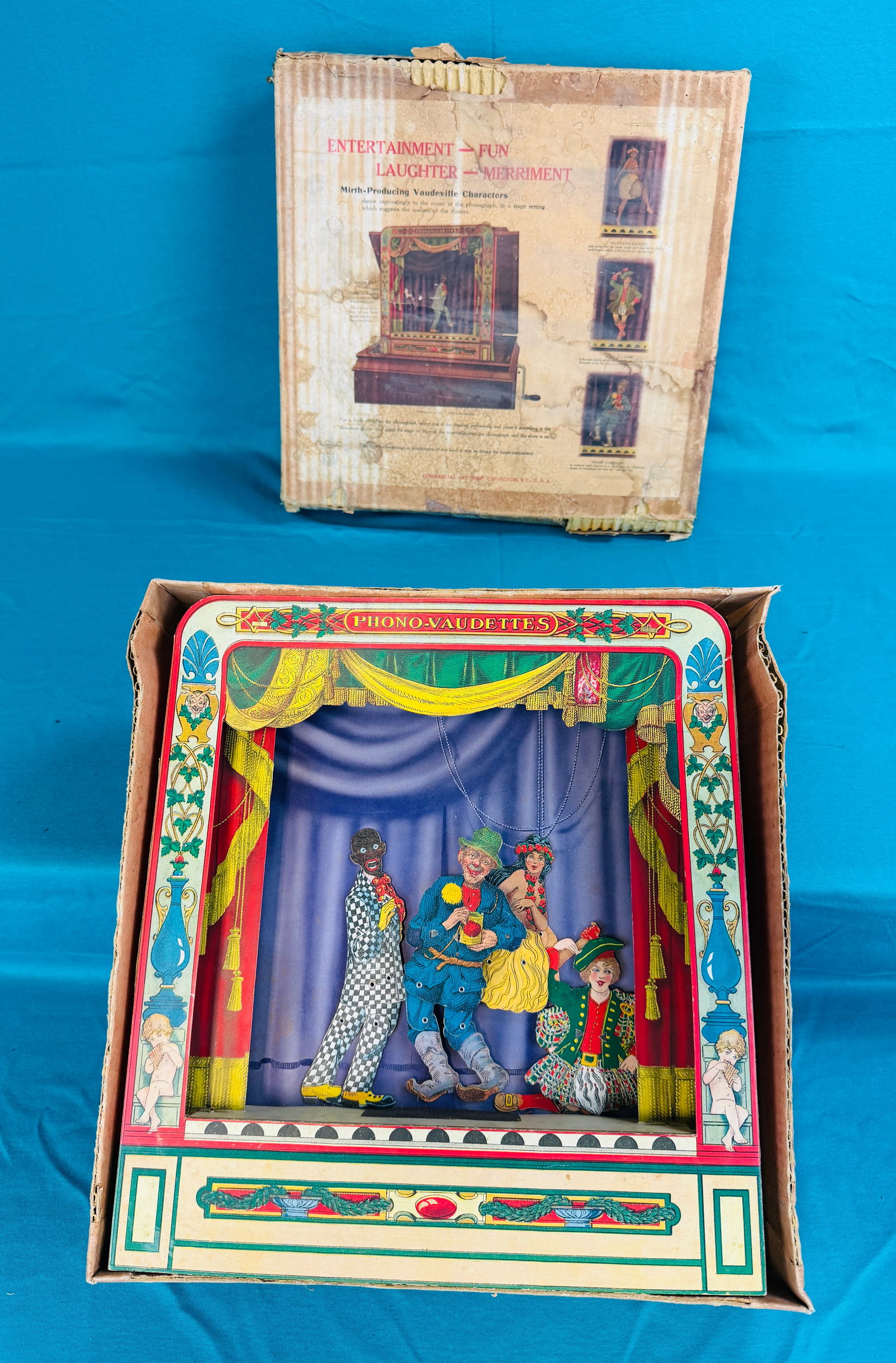 Scarce Phono-Vaudettes Phonograph Accessory Toy: Scarce Phono-Vaudettes Phonograph Accessory toy in its original box which was sold by the Commercial Art Shop Covington Kentucky. Item is approximately 14" wide and tall and when placed on a turning p