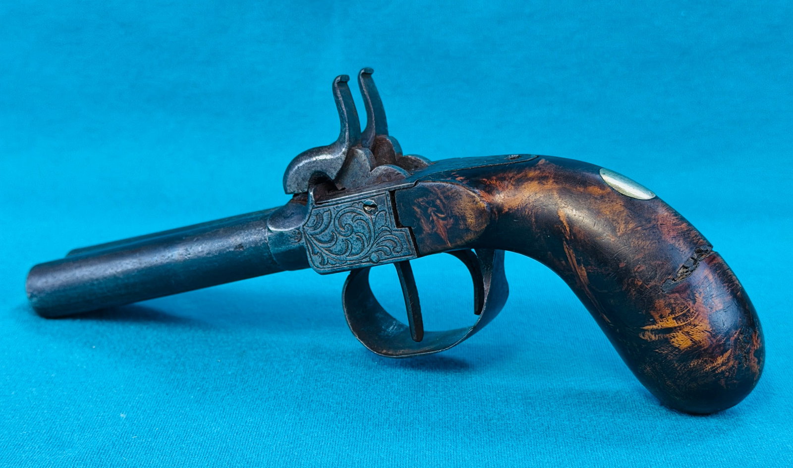 Antique Double Screw Barrel Percussion Pistol: Antique .44 caliber antique double screw barrel percussion pistol with engraved frame and trigger guard. The grips appear to be made from a well figured wood, possibly a form of burl. The pistol measu