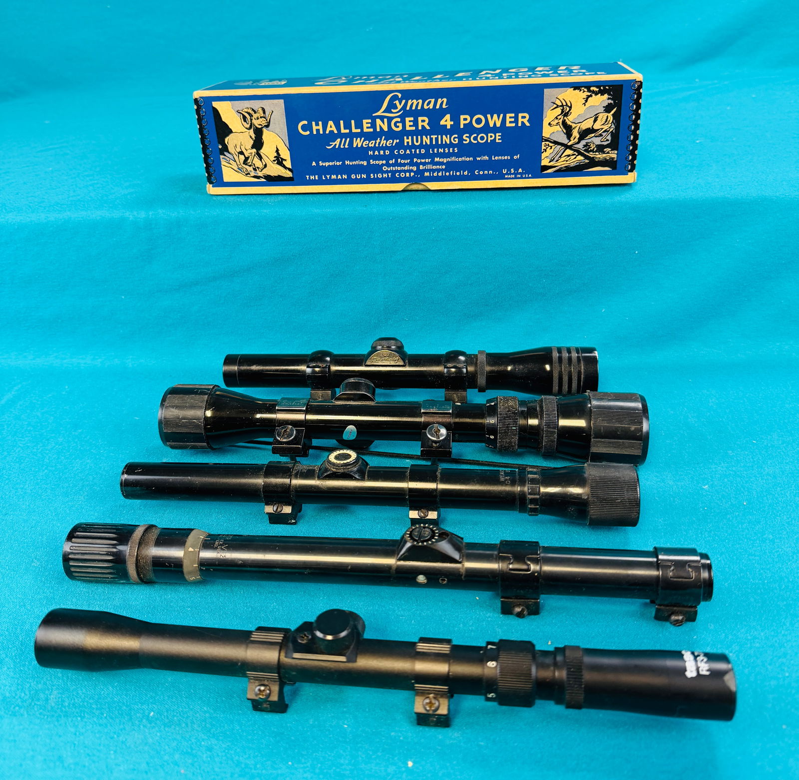 Lot Modern & Vintage Rifle Scopes Etc: Lot of modern and vintage rifle scopes along with a empty Lyman Challenger Rifle Scope box. Lot includes 2 3/4X Redfield, Tasco RF3-7X20, Western Field 3-9X33 60-1228 scope with Realist metal mounts,