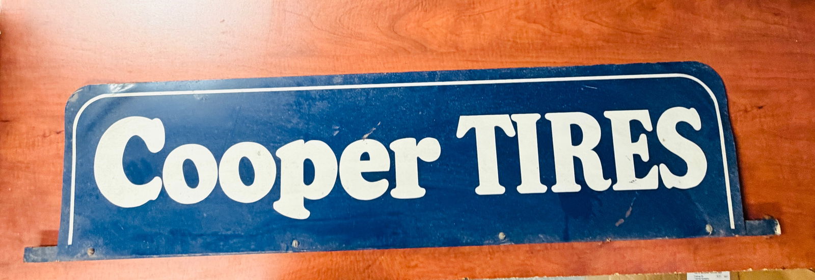 Vintage Cooper Tires Metal Rack Top Sign: Vintage rather heavy gauge lithograph on steel double sided Cooper Tires sign for the top of a rack which measures approximately 54" by 12". Condition- has some slight bending at ends and could use a