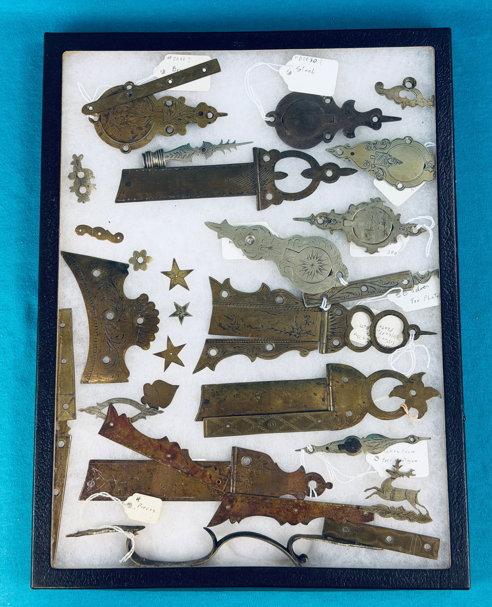 Large Lot Antique Gun Hardware: Large lot of antique gun hardware which includes items made from both brass and German Silver a number of which are ornately engraved. Lot includes patch box covers, butt plates, toe plates and variou