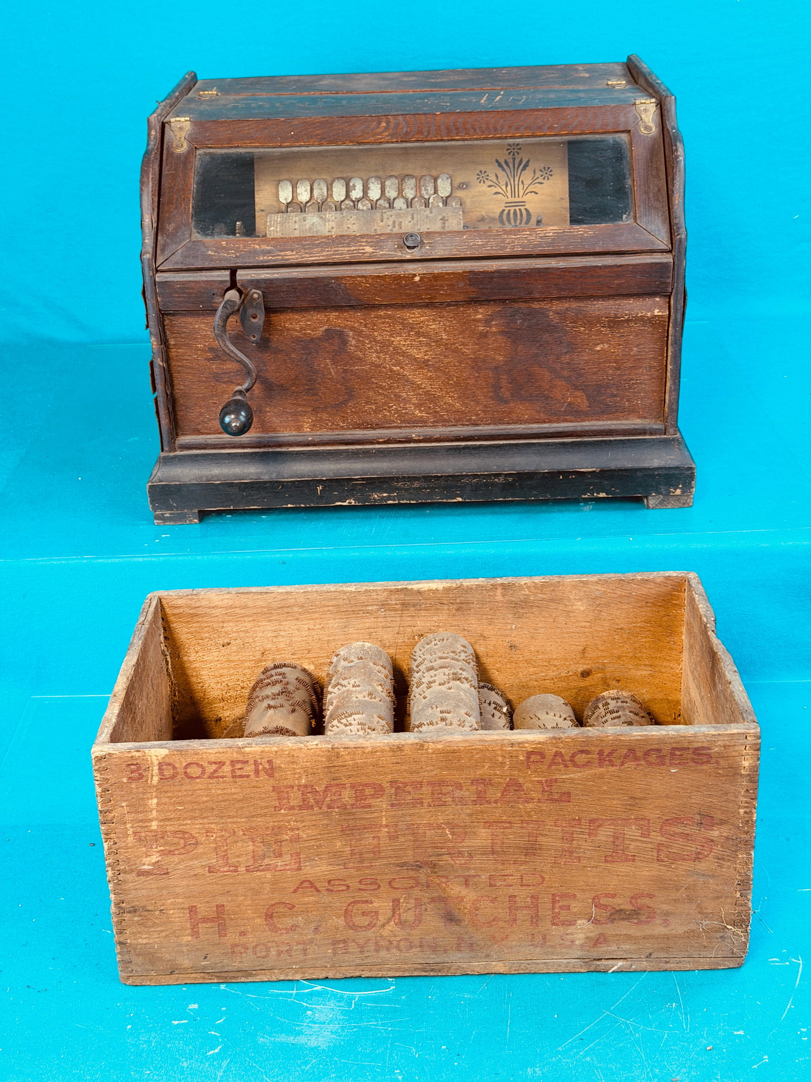 Ithaca Organ Co Concert Roller Organ w Rolls: Antique Ithaca Organ Company concert roller organ along with 16 additional organ rolls. Roller organ has its original crank but needs to have its bellows restored in order to function. No in house shi