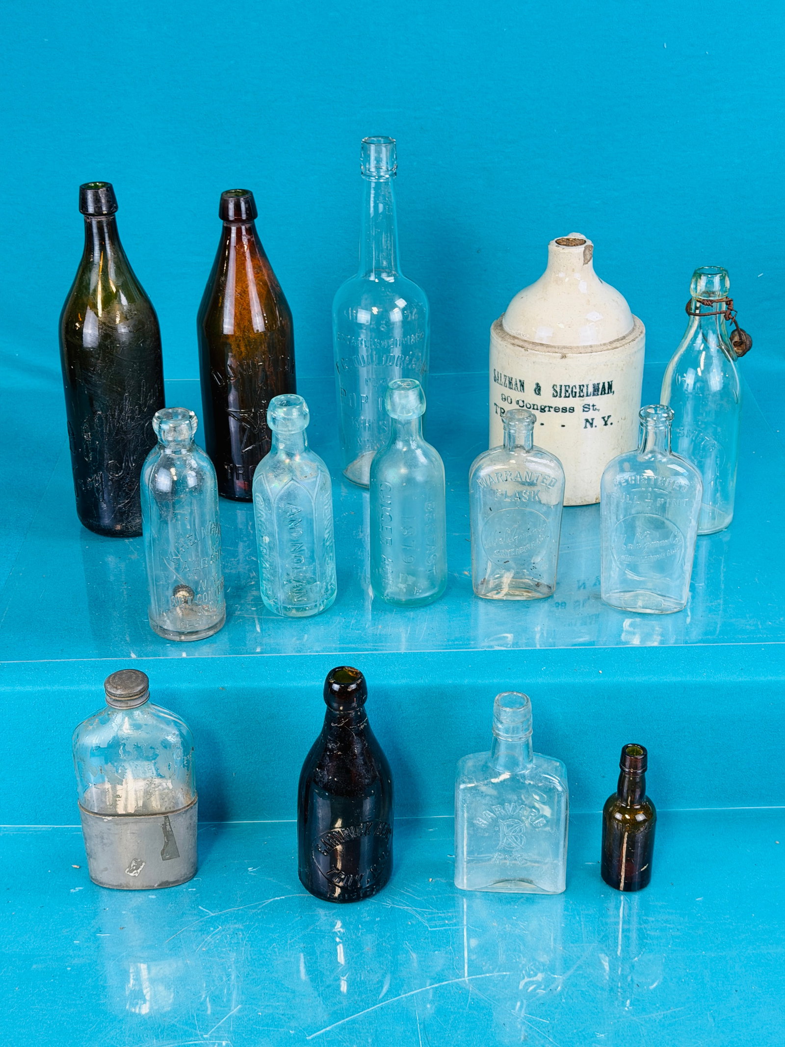Lot Capital Region Bottles Etc: Lot of antique Capital Region bottles and others which includes; two large variants D J Whelan Troy N.Y.; R.T. Smith Troy N.Y. lightning stoppered bottle, Carnrick Bros Troy N.Y., Hennessy & Nolan 187