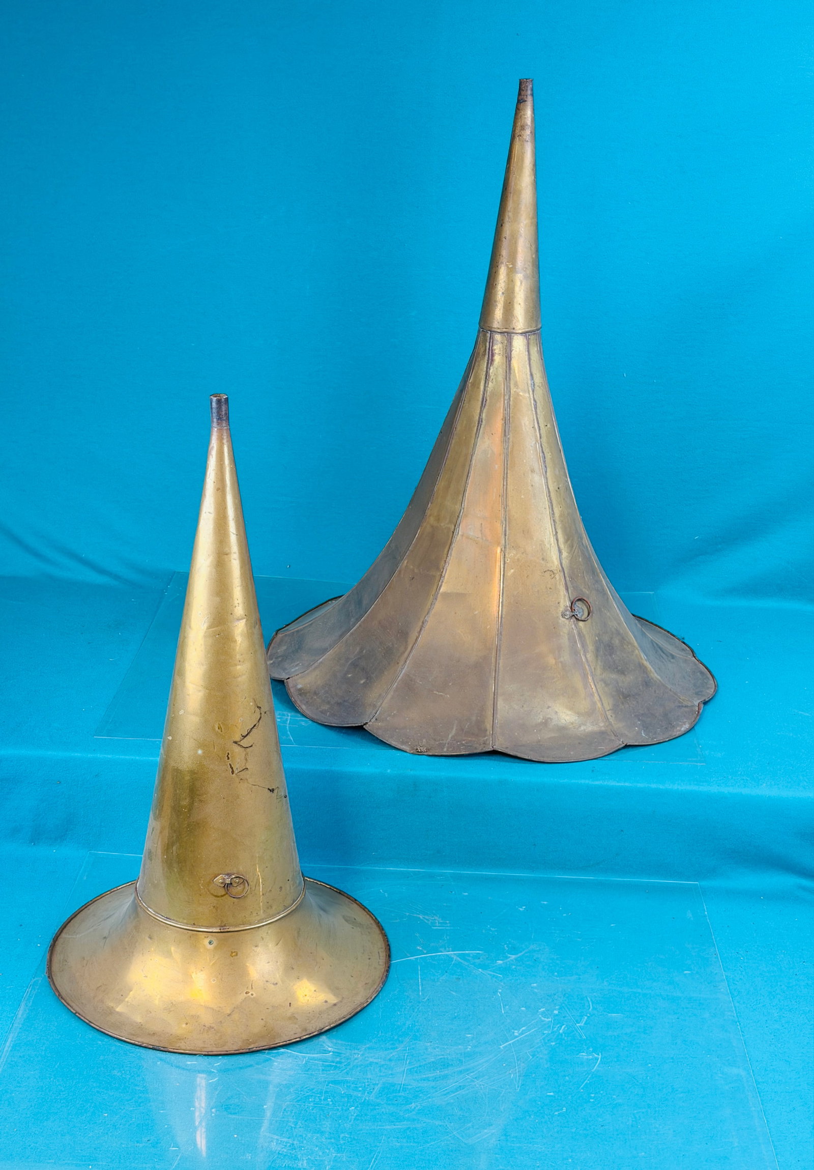 Lot 2 All Brass Phonograph Horns: Lot of two antique all brass phonograph horns one of which has eleven panels and is approximately 29" long with a 22 1/2" diameter bell. The second horn measures approximately 24" long and has a 14" d