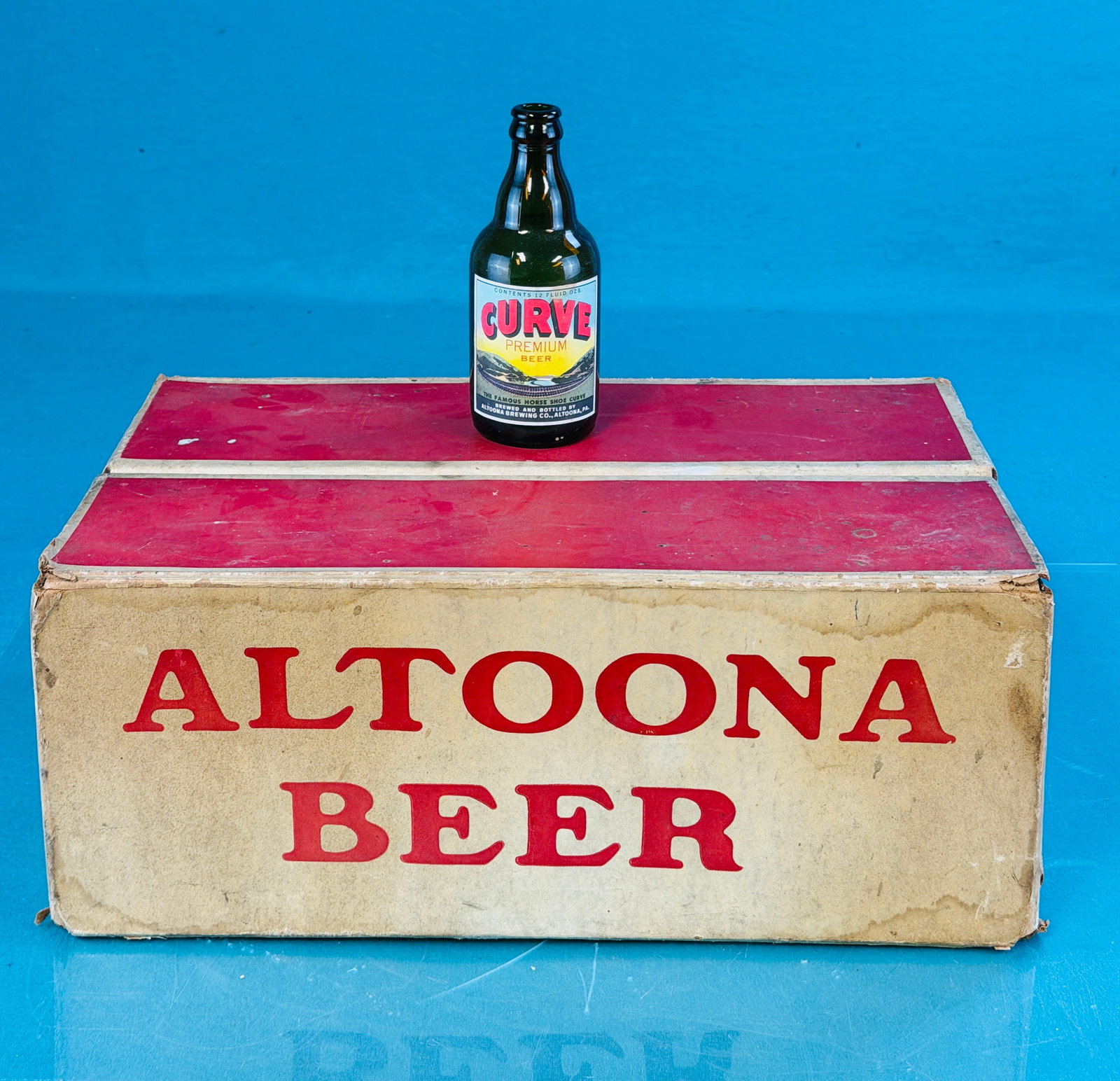 Full Case Altoona Brewing Co Pennsylvania Beer: Full case of 24 colorful labelled beer bottles from the Altoona Brewing Company Altoona Pennsylvania. Bottles each have a colorful label for Curve Premium Beer which depicts the famous horse shoe curv