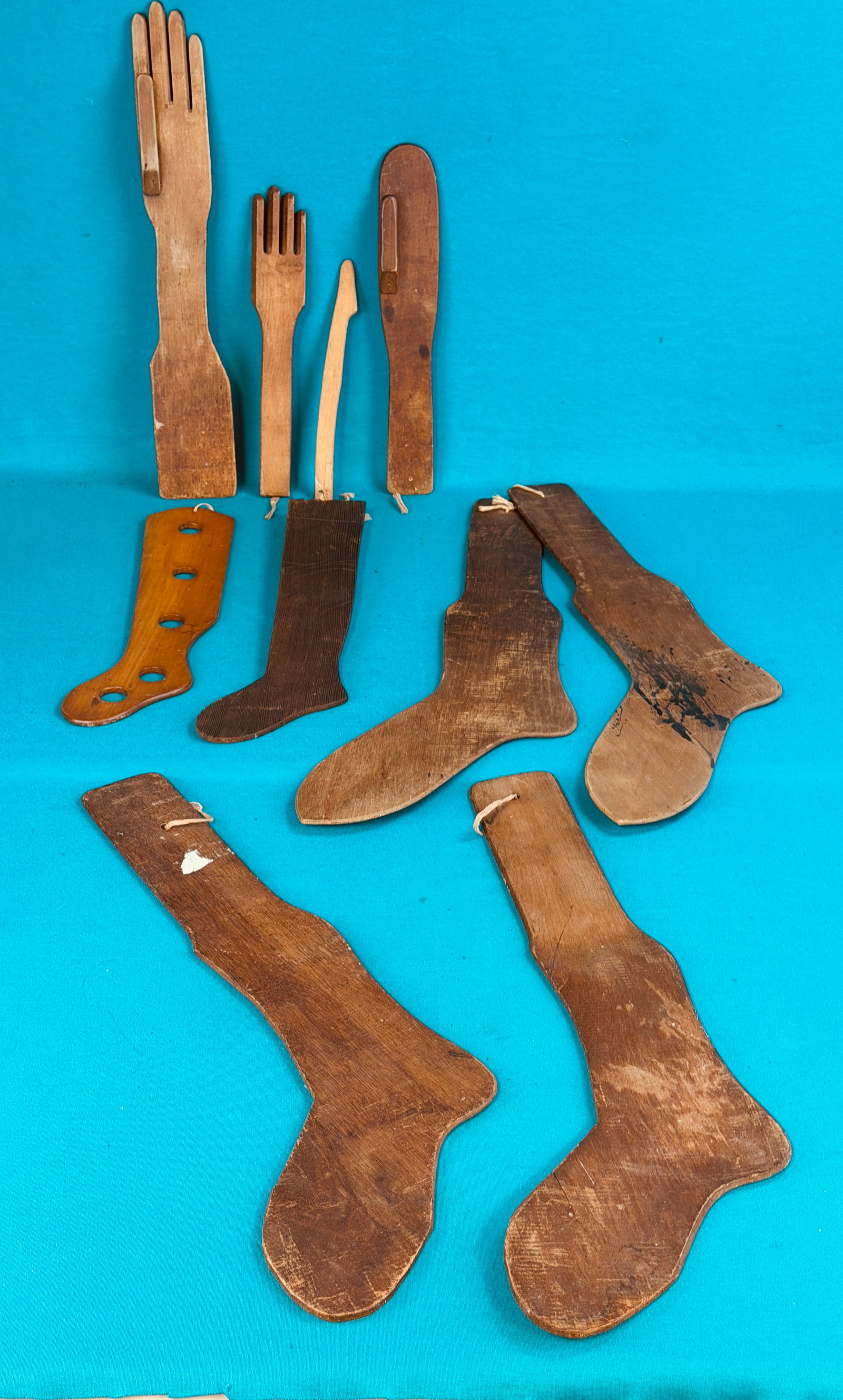 Lot 10 Antique Wooden Sock Forms: Lot of ten antique wooden sock forms the longest of which measures approximately 24 1/2" long. Condition - is as shown. In house shipping is available on this lot.