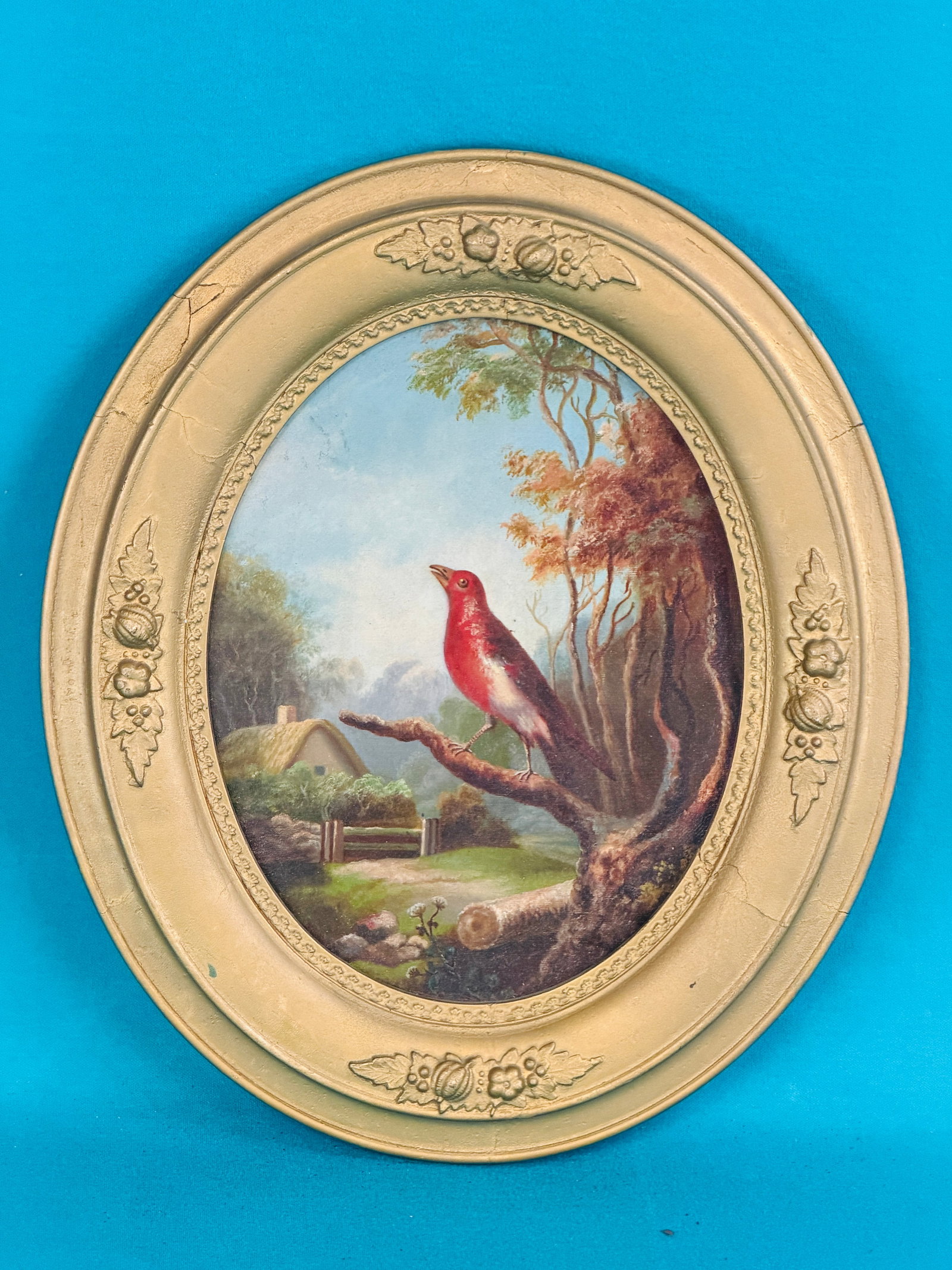 Antique Oil Painting Of A Bird In Landscape: Antique 19th century oil painting on canvas which depicts a red bird on a branch in a landscape setting. Painting measures approximately 9 1/4" by 7 1/4" (sight) in a period oval frame which measures 