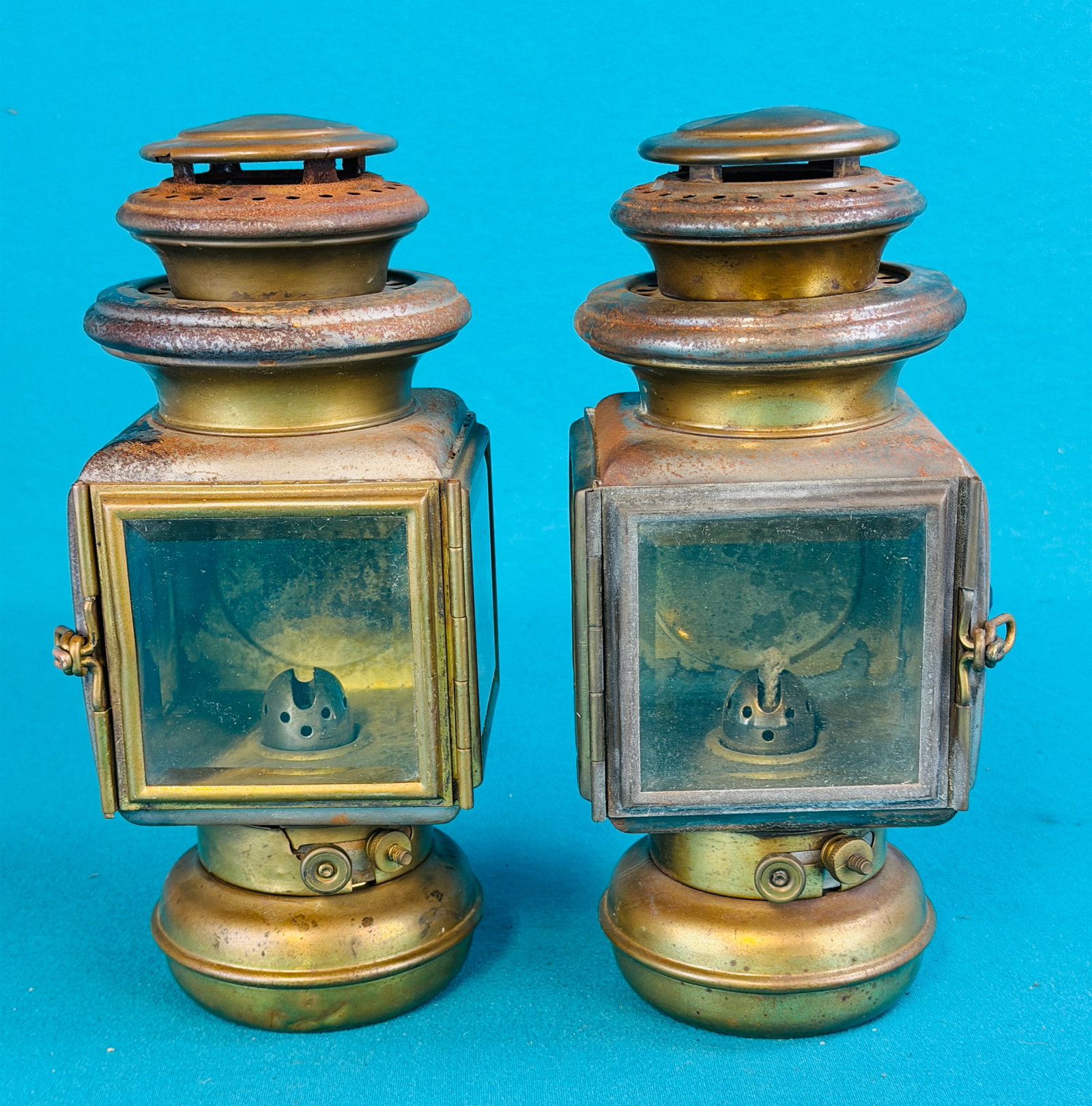 PR Corcoran Lamp Co Automobile Lamps: Matched pair of antique kerosene automobile lamps which were made and are marked by the Corcoran Lamp Company Cinti Ohio. Lamps are made of sheet iron and brass with beveled glass windows. Condition -