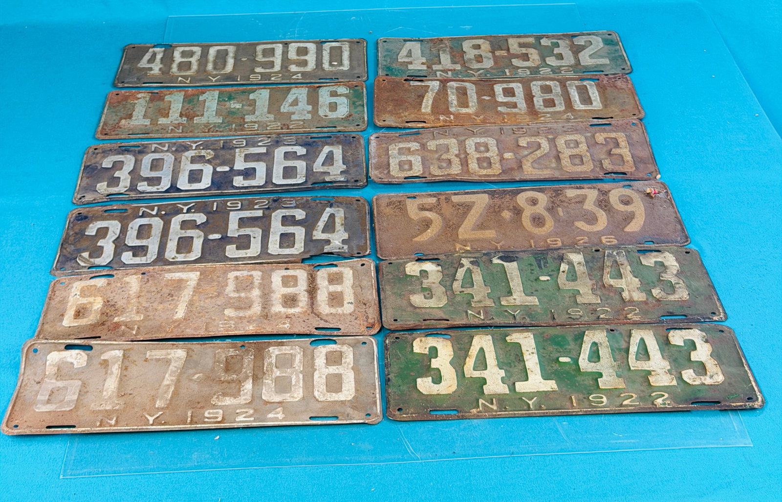 Lot 12 1920's NYS License Plates Incl Three Pair: Lot of twelve 1920's New York State license plates which includes three pair. Condition - is as shown. In house shipping is available on this lot. Approximate weight is 10 pounds.