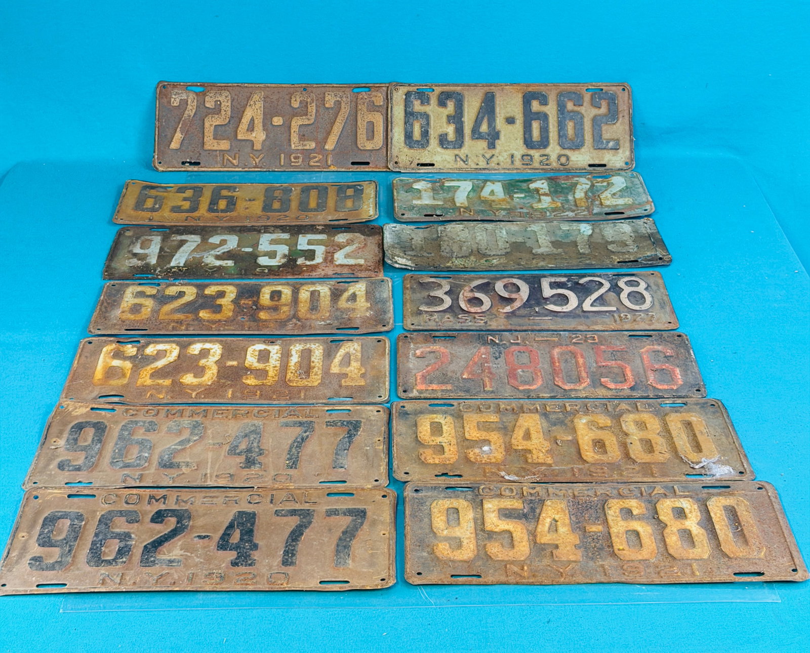Lot 14 1920's License Plates Incl Commercial: Lot of thirteen 1920's License plates which include two pair of commercial NYS plates, a pair of 1921 NYS plates, a single 1923 New Jersey plate, a single 1927 Massachusetts plate and six additional N