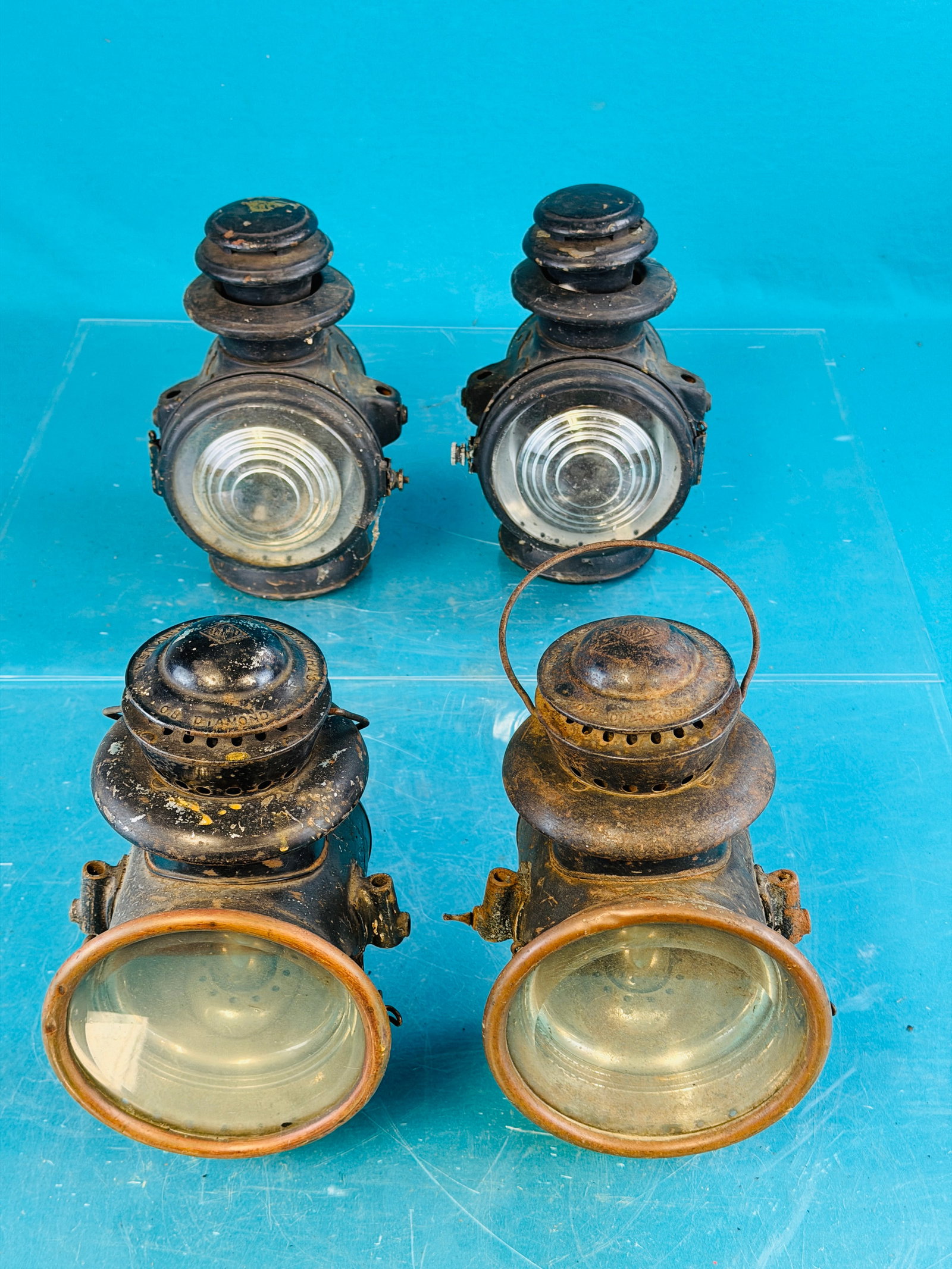 Lot 2 Pair Antique Automotive Lamps: Lot of two pair antique automobile kerosene driving lamps which include a pair marked IMPD 08 Diamond made by the C.T. Ham Mfg. Co Rochester New York. These lamps are made of sheet iron with brass bez