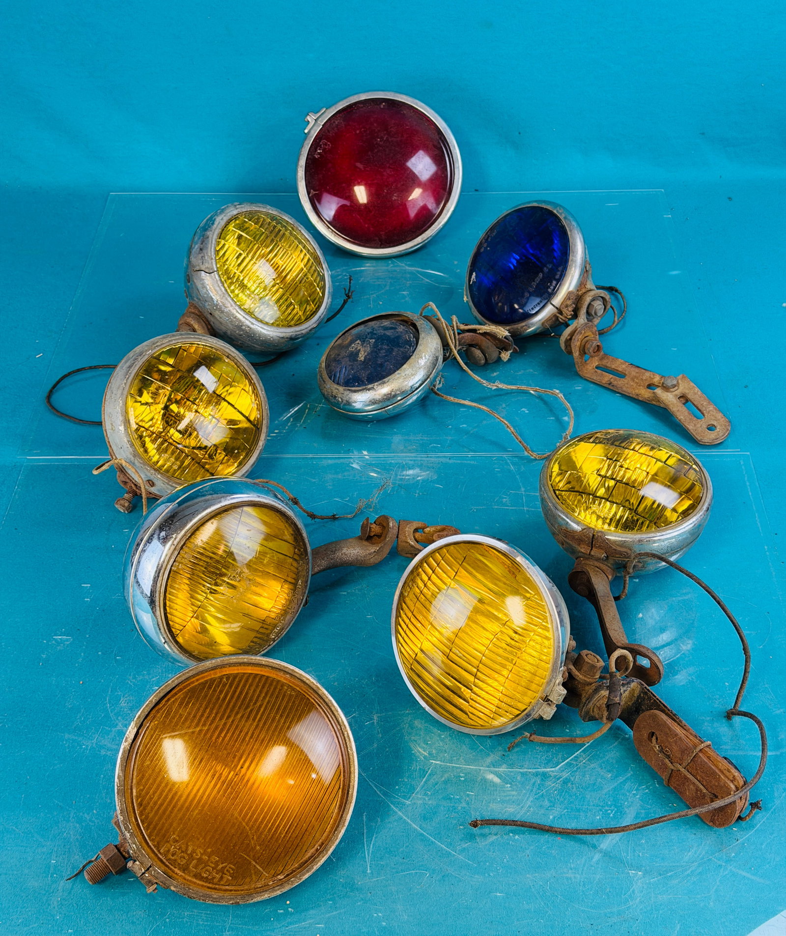 Lot 9 Antique Auto Lights Including Fog Etc: Lot of nine antique and vintage automotive lights which include some yellow lens fog lights, a red and two blue lens lights. Condition - is as shown in need of restoration. No in house shipping is ava