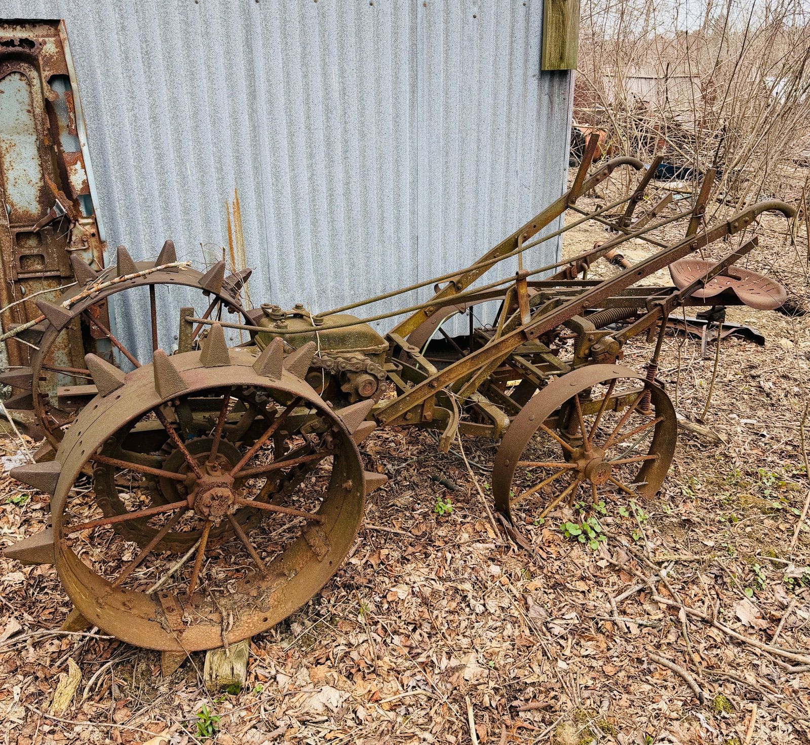 Antique Farm Tractor Hit & Miss Engine: Antique Farm Tractor with Hit & Miss Engine (unknown maker). We could not find any plate from a manufacturer and it appears it is all there. It is unknow when it was last run, it is unknown if the whe