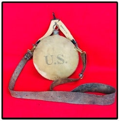 U.S. Army Canteen Dated 1907 w 1903 Carry Strap: United States Army canvas covered metal canteen which is marked on the front R.I.A. (Rock Island Arsenal) along with the date 1907. The canteen comes with two carry straps one a belt strap marked R.I.