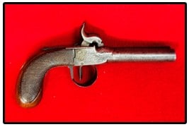 Belgium Double Barrel Percussion Pistol: Belgium double barrel percussion pistol which measures approximately 7 1/2" long. One hammer works as it should while the other does not function as it will not lock in place. There is some pitting to