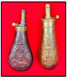 Lot 2 Antique Copper & Brass Powder Flasks: Lot of two antique copper and brass gun powder flasks one of which measures approximately 6 3/4" tall and has a embossed scene of a Scottish Highlander which has a top marked by the American Flask & C