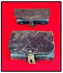Lot 2 Indian Wars Era Cartridge Boxes: Lot of two Indian Wars Era cartridge boxes both of which appear to be unmarked as far as maker. The one cartridge box has US impressed on the front flap. The smaller cartridge box has a replaced woode